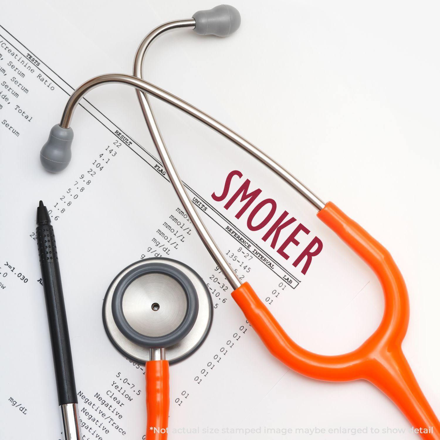 A stethoscope, pen, and medical document stamped with SMOKER using the Large Self Inking Smoker Stamp.