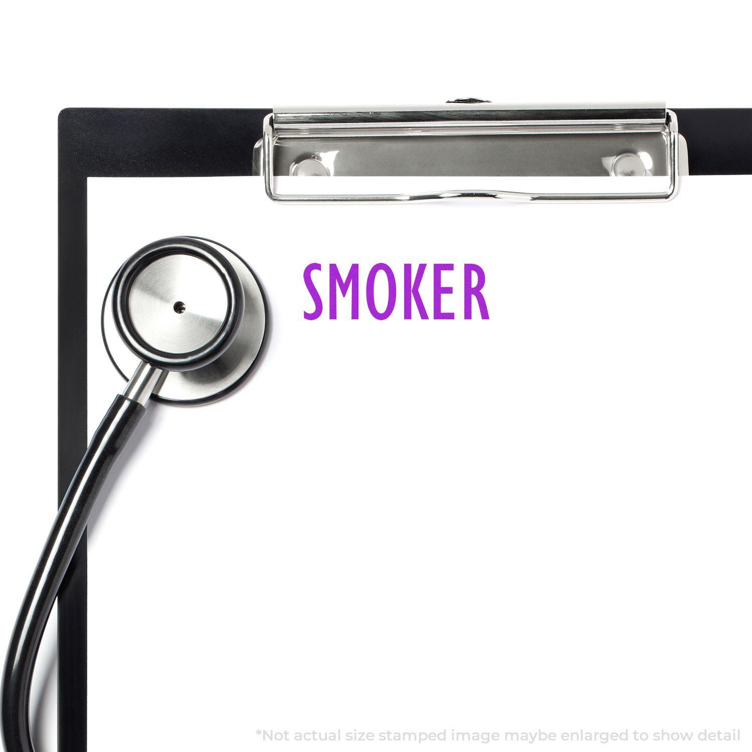 Slim Pre-Inked Smoker Stamp used on a medical clipboard with a stethoscope beside it.