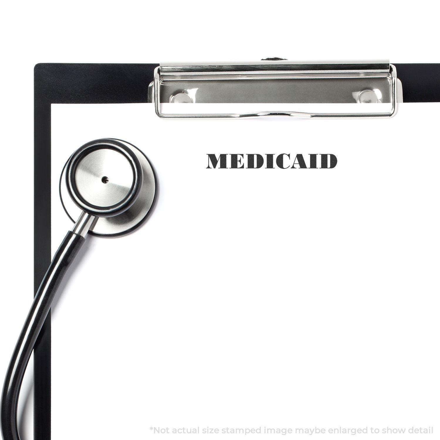 Clipboard with stethoscope and Large Pre-Inked Medicare Stamp imprint on paper, showing MEDICAID in bold letters.