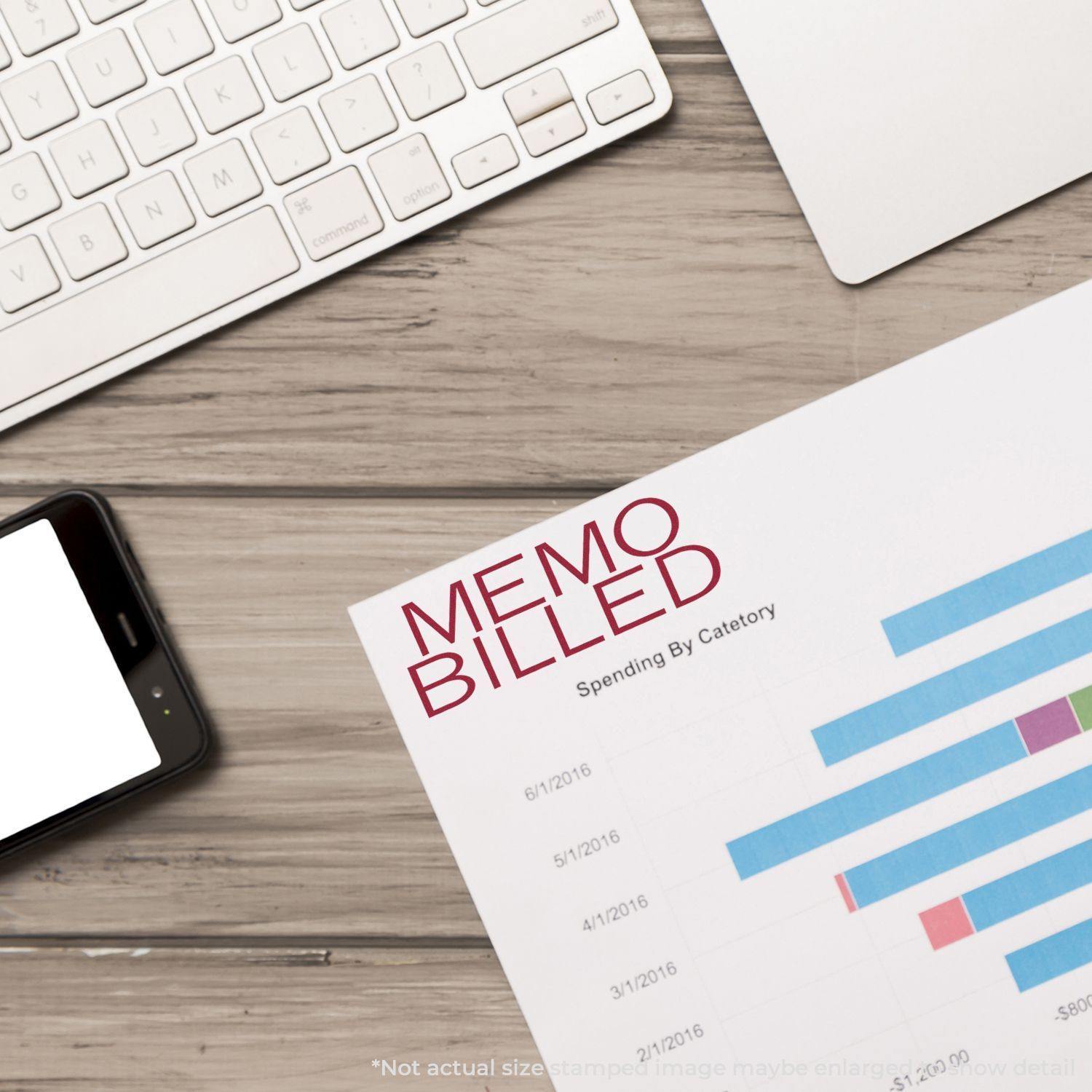 Large Memo Billed Rubber Stamp used on a financial document next to a keyboard and smartphone on a wooden desk.