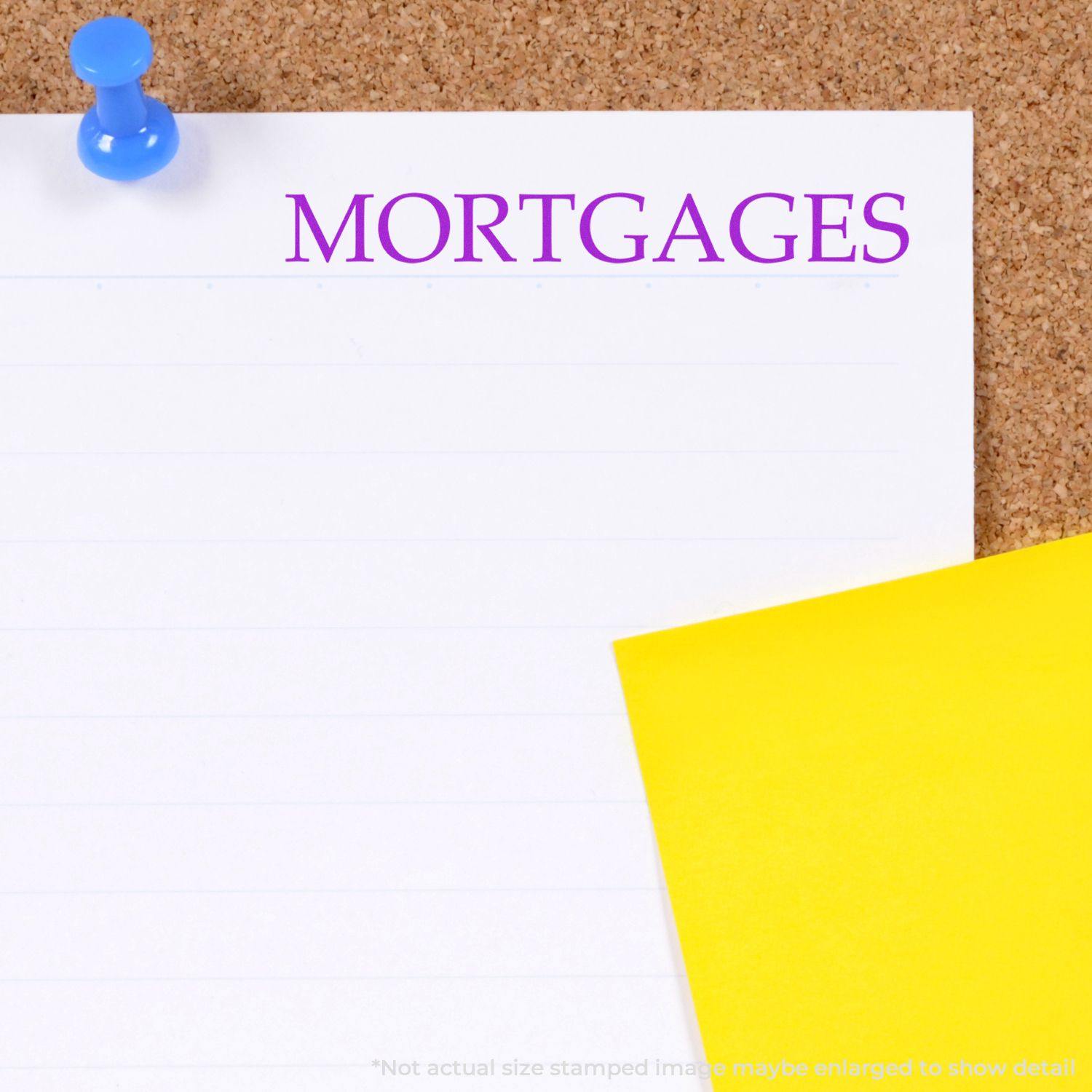 Large Mortgages Rubber Stamp used on a white paper pinned to a corkboard with a blue pushpin and a yellow paper nearby.