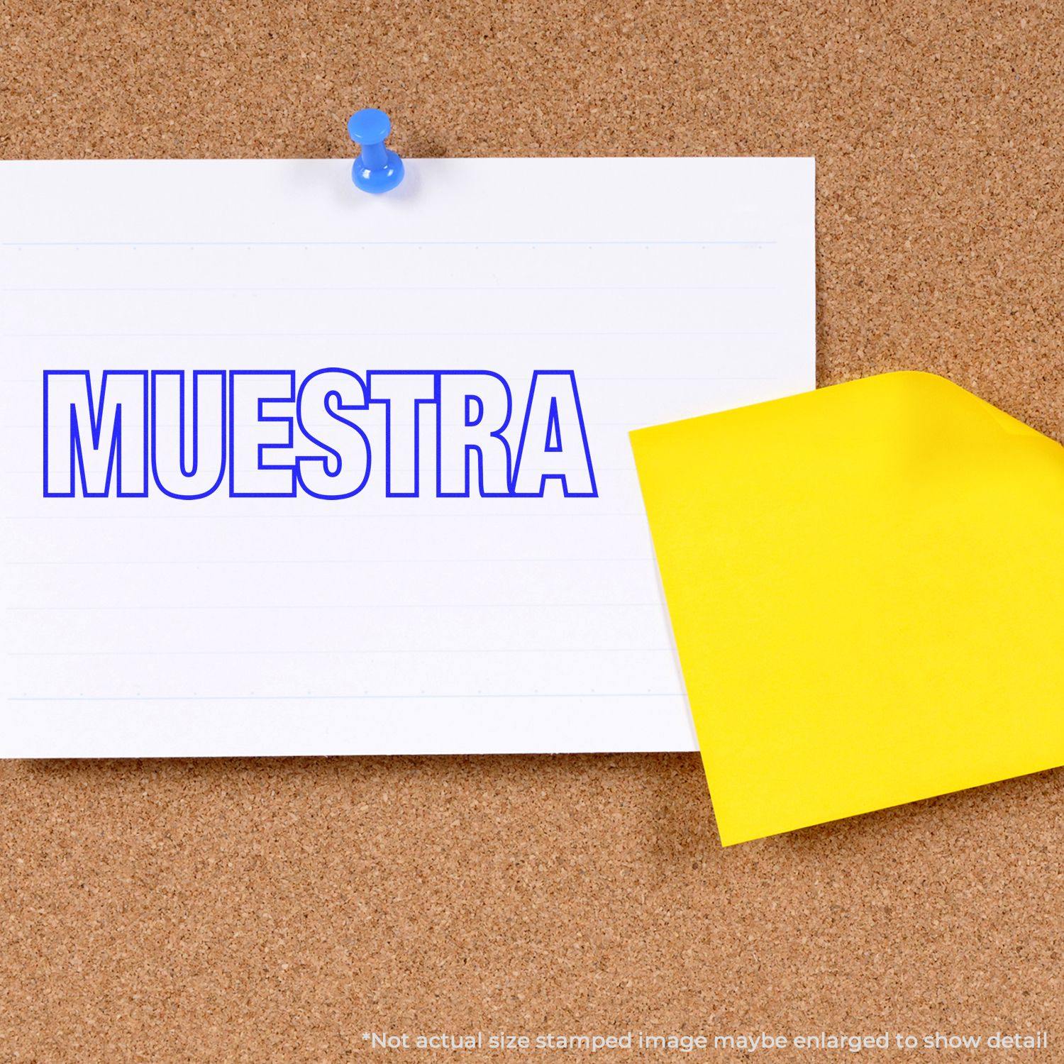 Large Pre-Inked Muestra Stamp used on a white paper pinned to a corkboard, with a yellow sticky note partially visible.