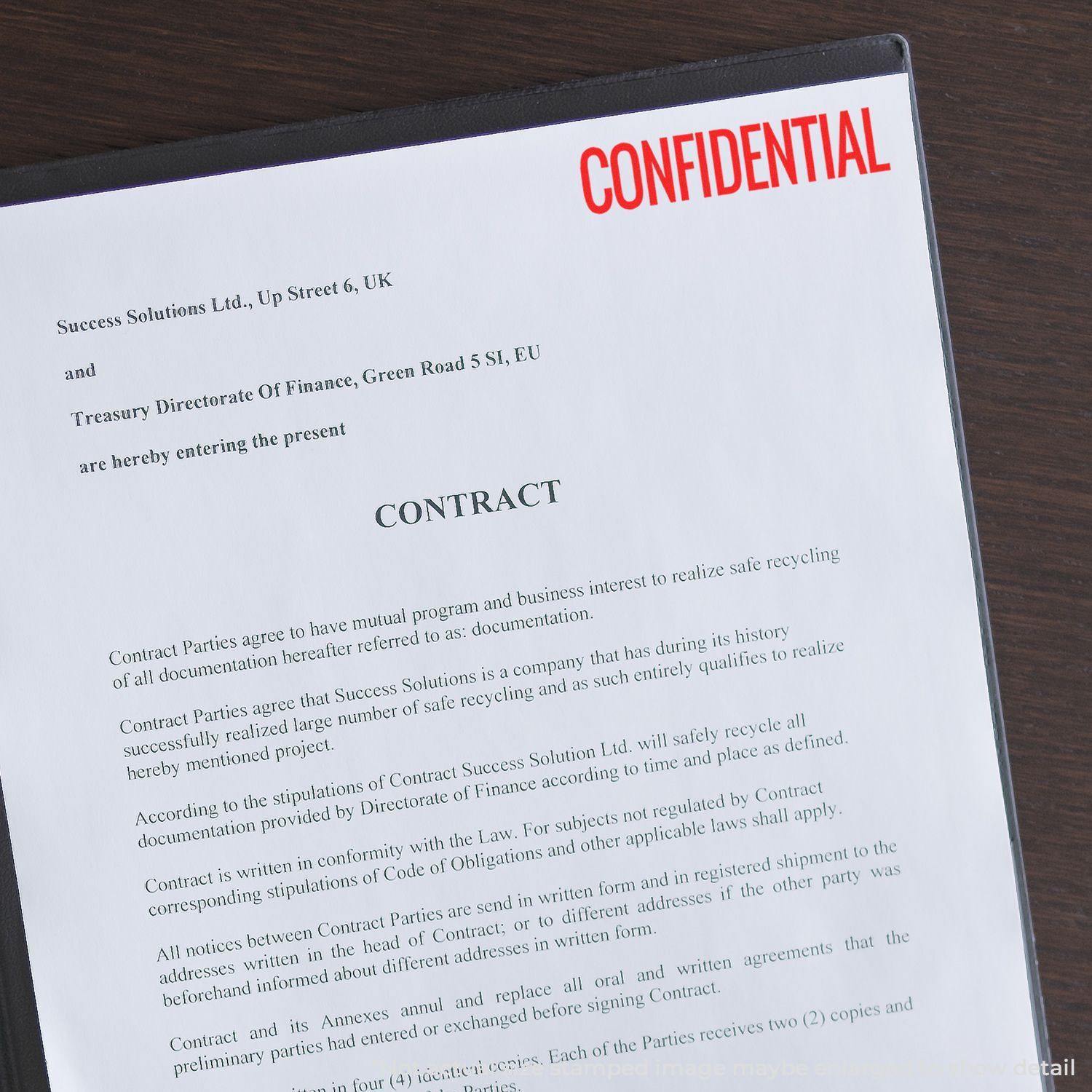 A document stamped with a Large Narrow Confidential Rubber Stamp in red ink, indicating the sensitive nature of the contract.