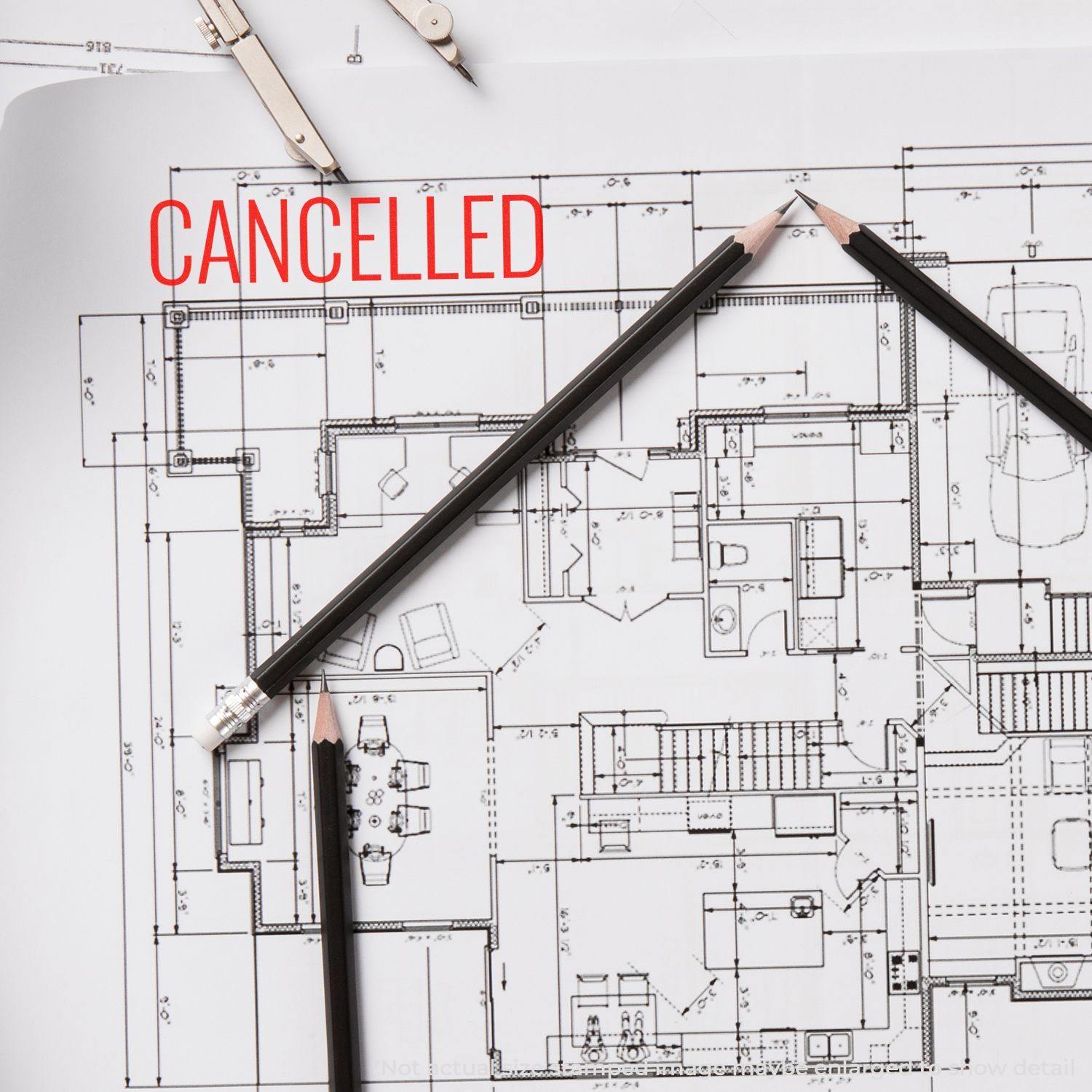 Architectural blueprint with CANCELLED stamped in red using the Large Pre-Inked Narrow Font Cancelled Stamp, surrounded by pencils and a compass.