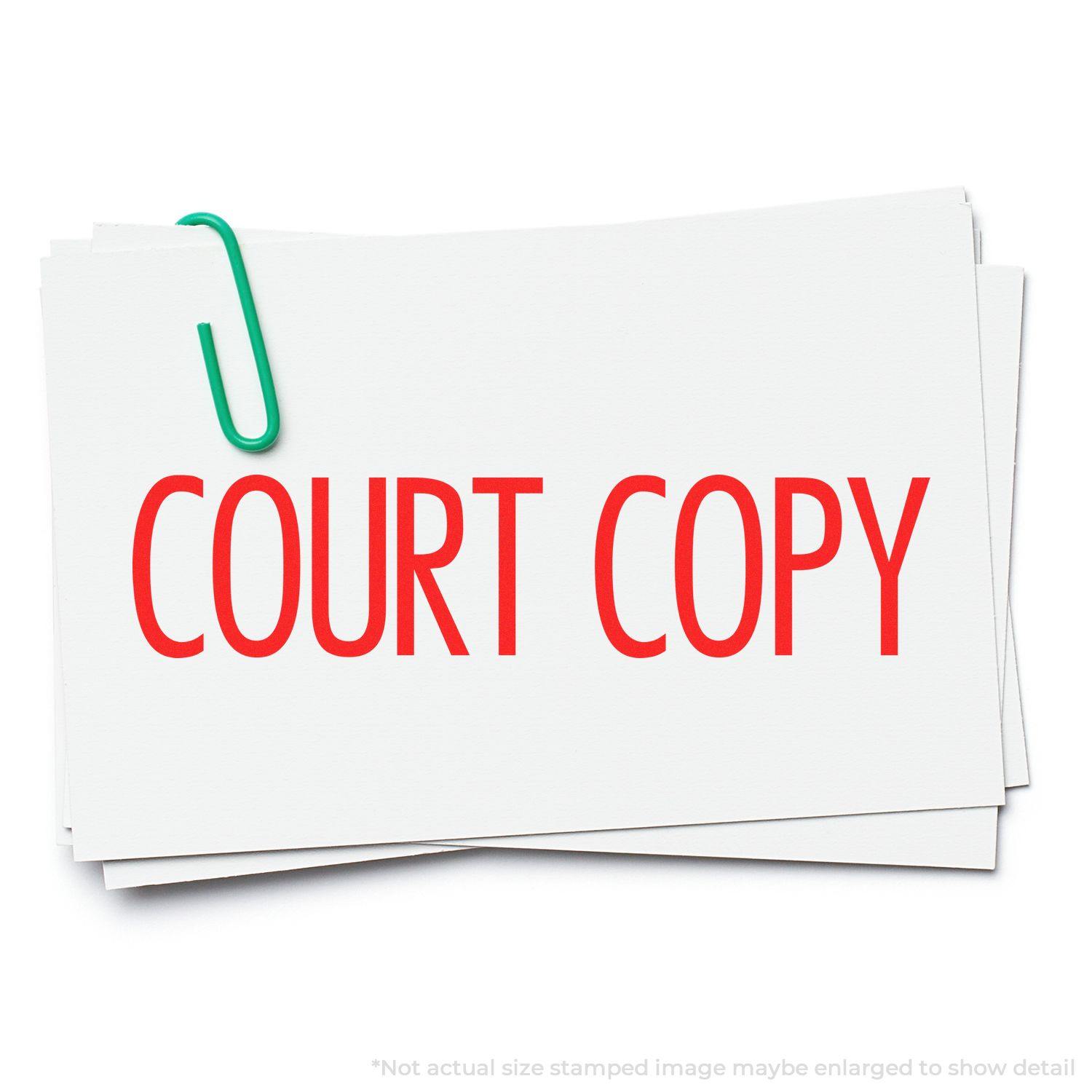 Large Narrow Font Court Copy Rubber Stamp in red ink on white paper, secured with a green paperclip.