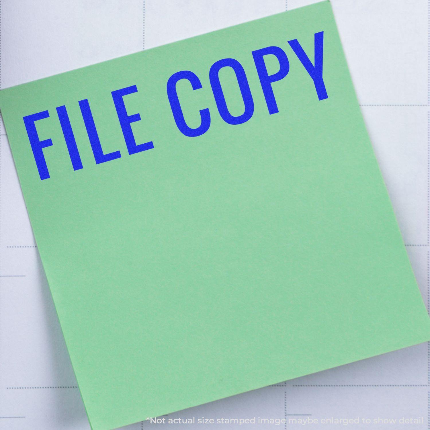 Green paper stamped with FILE COPY in blue using a Slim Pre-Inked Narrow Font File Copy Stamp.