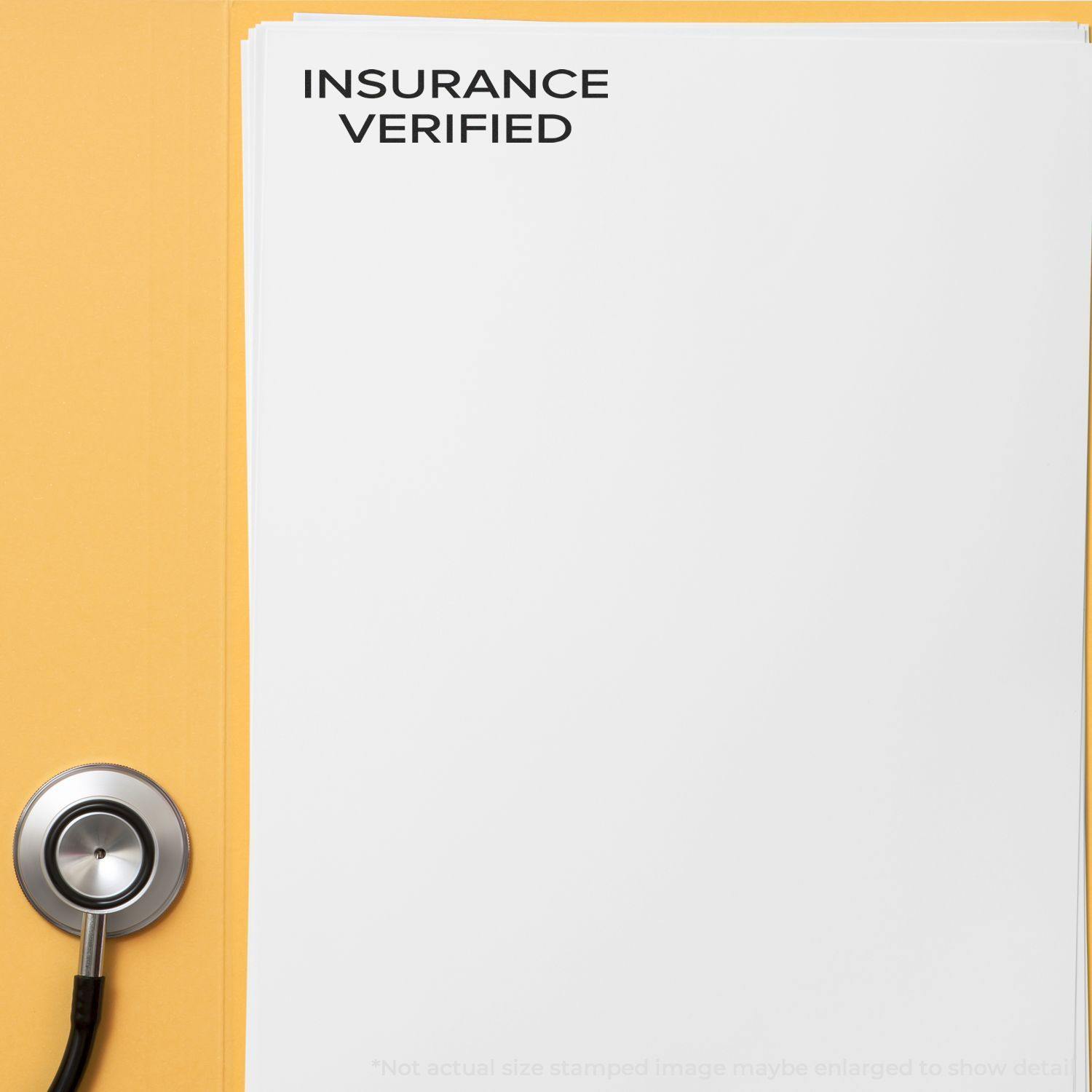 Slim Pre-Inked Narrow Font Insurance Verified Stamp on white paper beside a stethoscope on a yellow background.