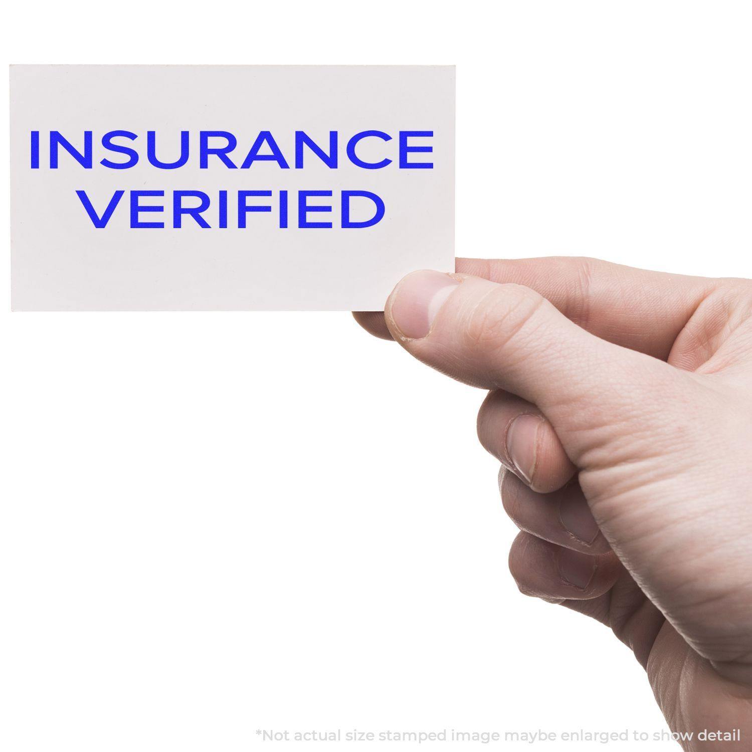 A hand holds a card stamped with INSURANCE VERIFIED using the Large Pre-Inked Narrow Font Insurance Verified Stamp.