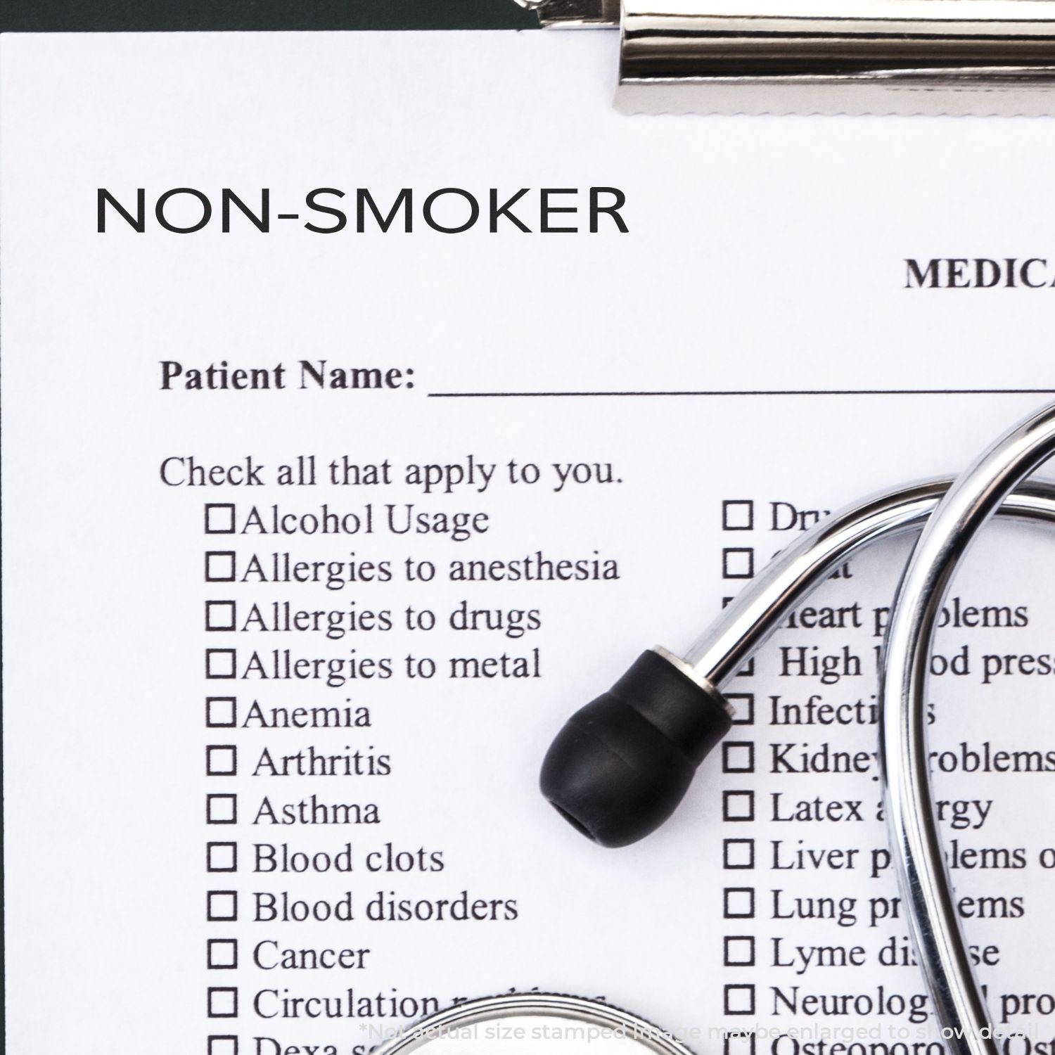 Large Narrow Font Non-Smoker Rubber Stamp used on a medical form with a stethoscope placed on top.