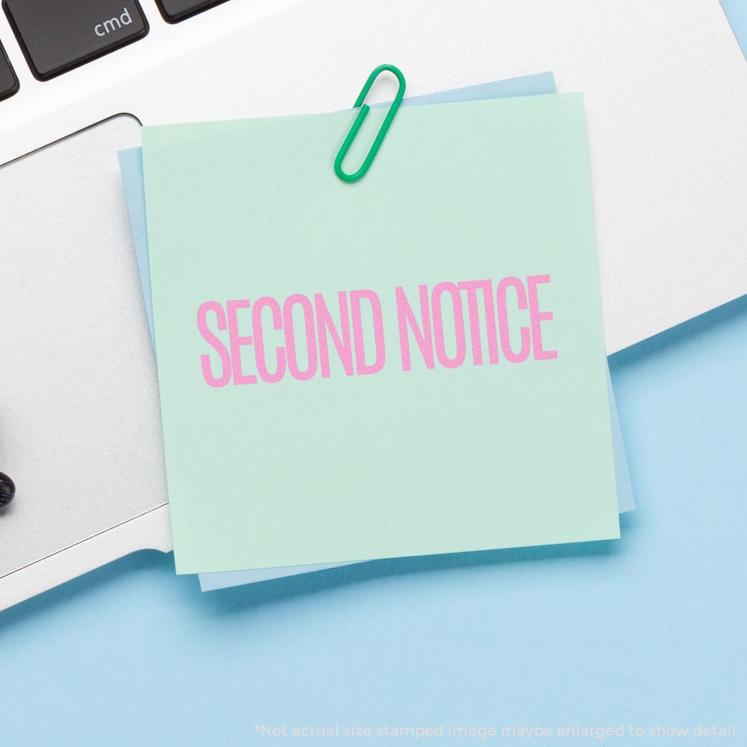 A mint green sticky note with SECOND NOTICE stamped in pink using the Large Pre-Inked Narrow Font Second Notice Stamp, clipped to a laptop.