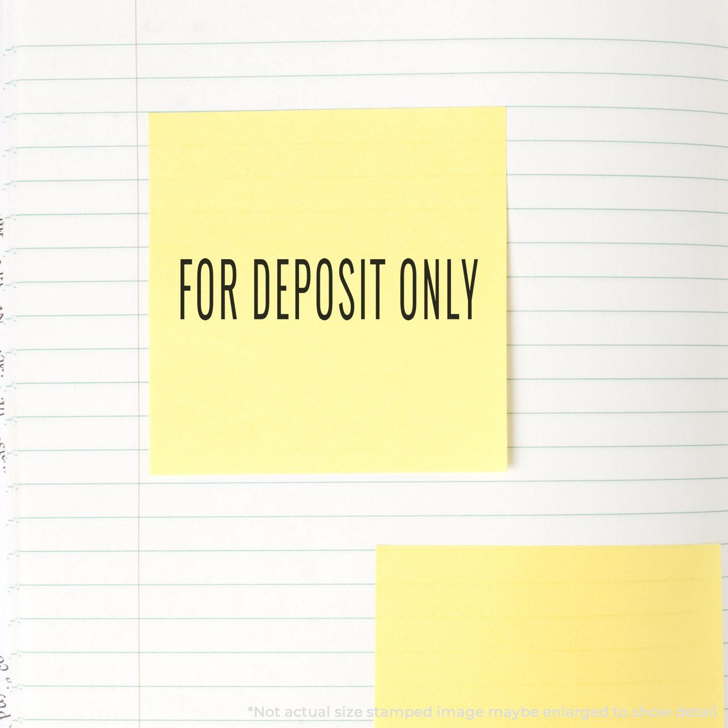 Large Pre-Inked Narrow For Deposit Only Stamp used on a yellow sticky note placed on a lined notebook page.