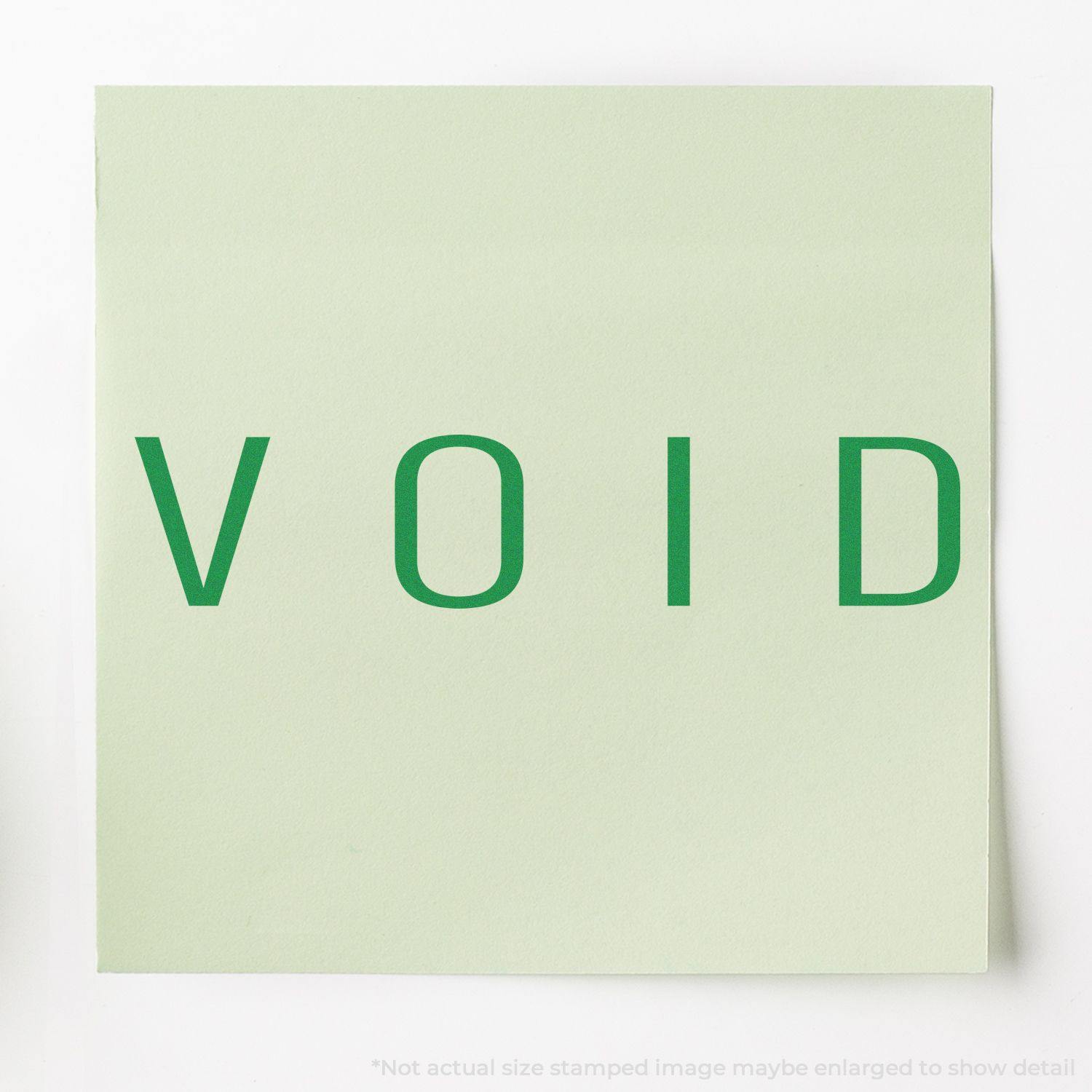 Green VOID text stamped on light green paper using the Large Narrow Void Rubber Stamp.