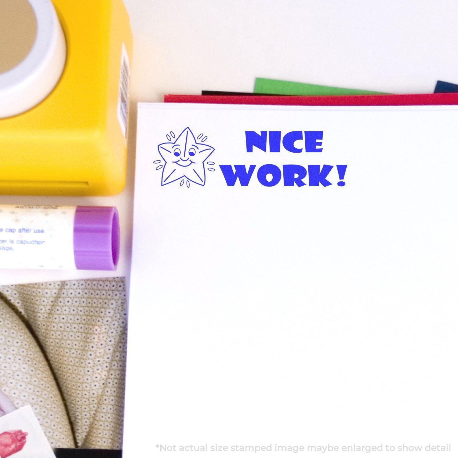 Slim Pre-Inked Nice Work Stamp used on white paper, showing a smiling star and the words Nice Work! in blue ink.