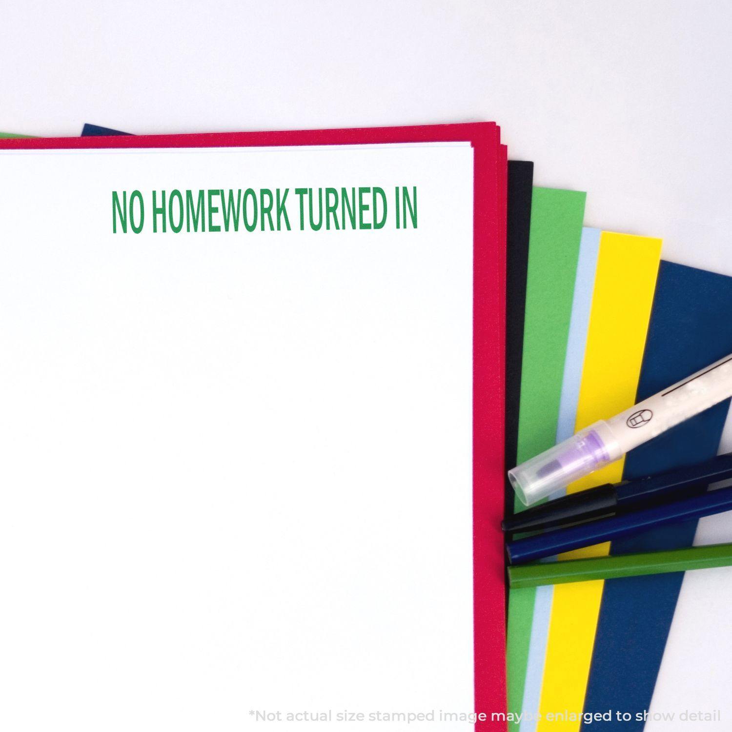 A stack of colorful papers with a No Homework Turned In mark from the Large Self Inking No Homework Turned In Stamp, alongside pens.