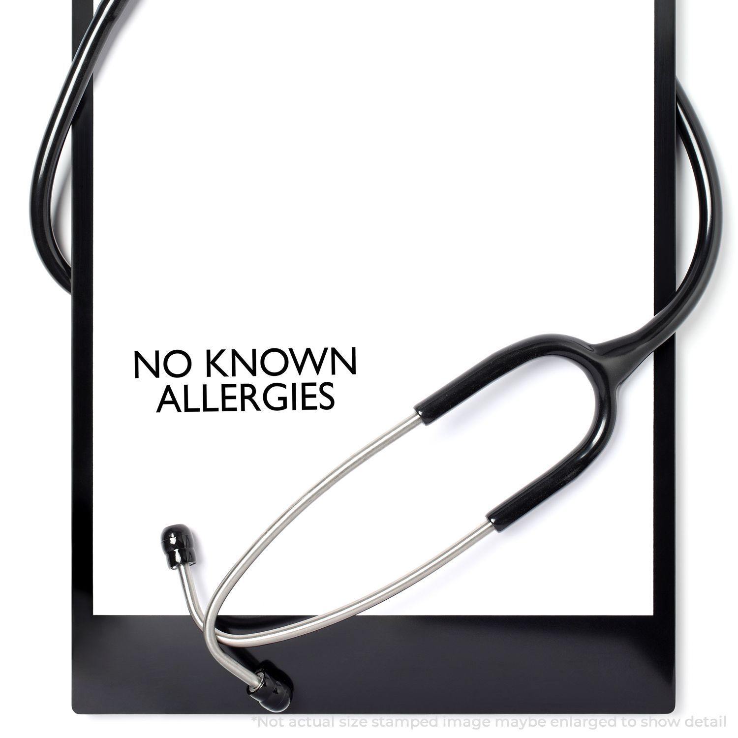 A stethoscope on a clipboard with a stamped message NO KNOWN ALLERGIES using the Large No Known Allergies Rubber Stamp.