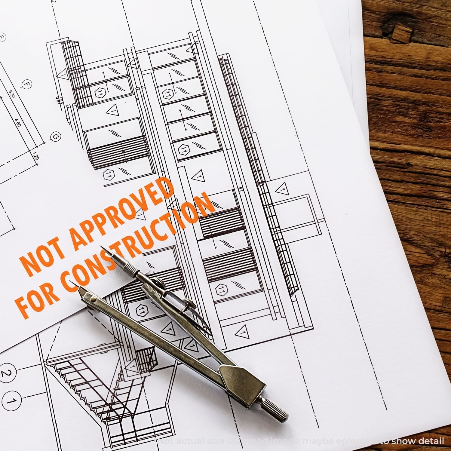 Self Inking Not Approved For Construction Stamp on architectural plans with a compass, indicating the plans are not approved for construction.