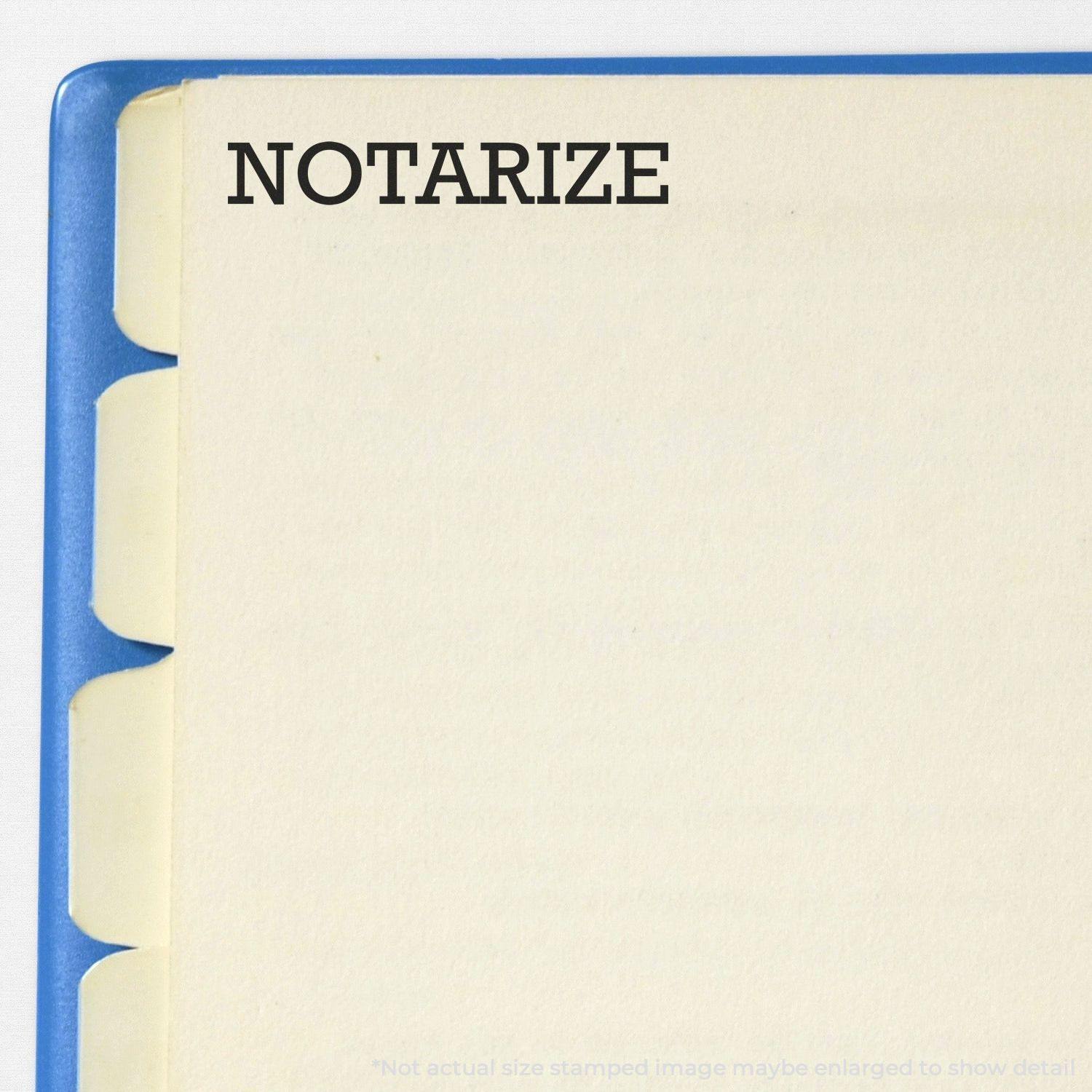 A Large Notarize Rubber Stamp imprint on a beige page with blue tab dividers, showing the word NOTARIZE in bold black letters.