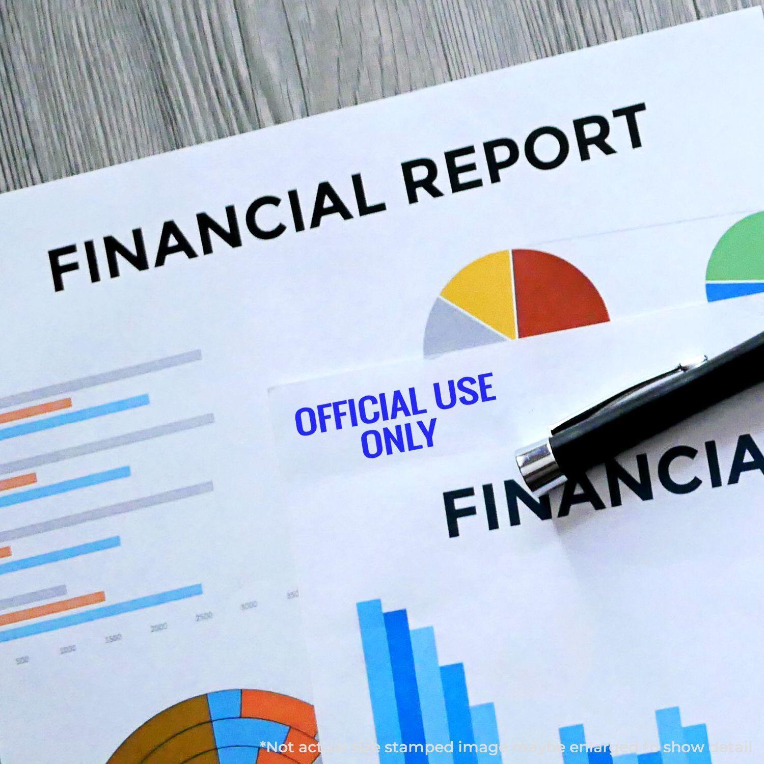 Large Pre-Inked Official Use Only Stamp marking a financial report with charts and graphs, alongside a pen on a wooden desk.