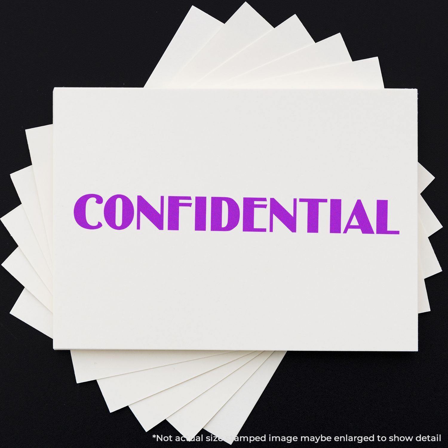 Large Optima Confidential Rubber Stamp in use, stamping CONFIDENTIAL in purple ink on white paper.