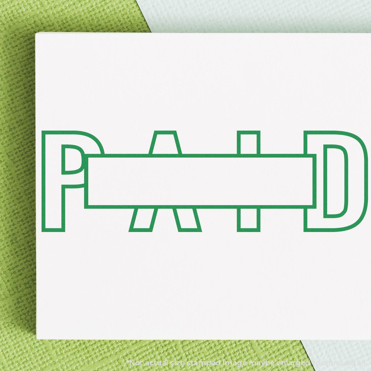 Large Pre-Inked Outline Paid with Box Stamp in green ink on white paper, showing the word PAID with a box in the center.