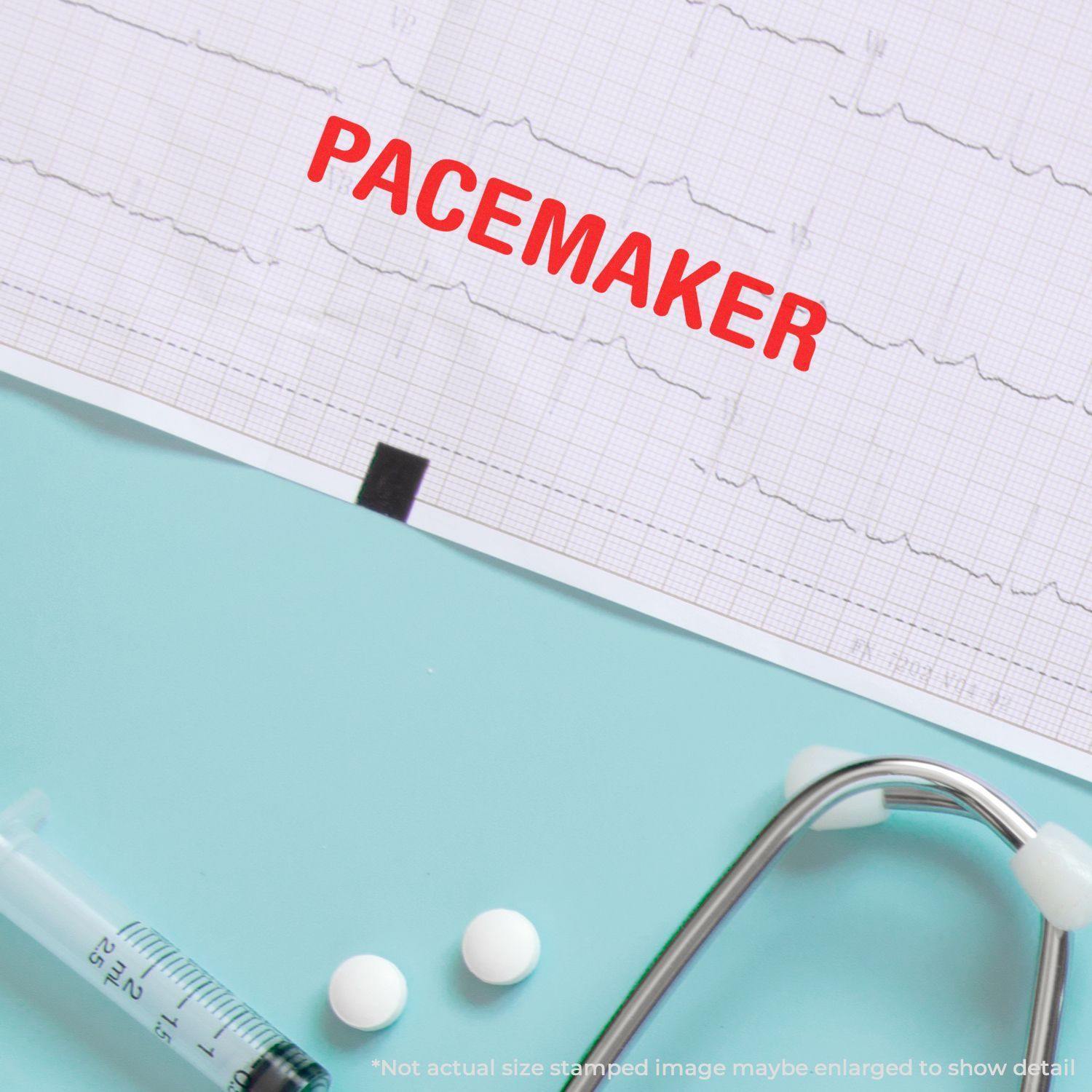 Large Pacemaker Rubber Stamp marking PACEMAKER in red on an ECG paper, with medical tools like a syringe, pills, and stethoscope nearby.