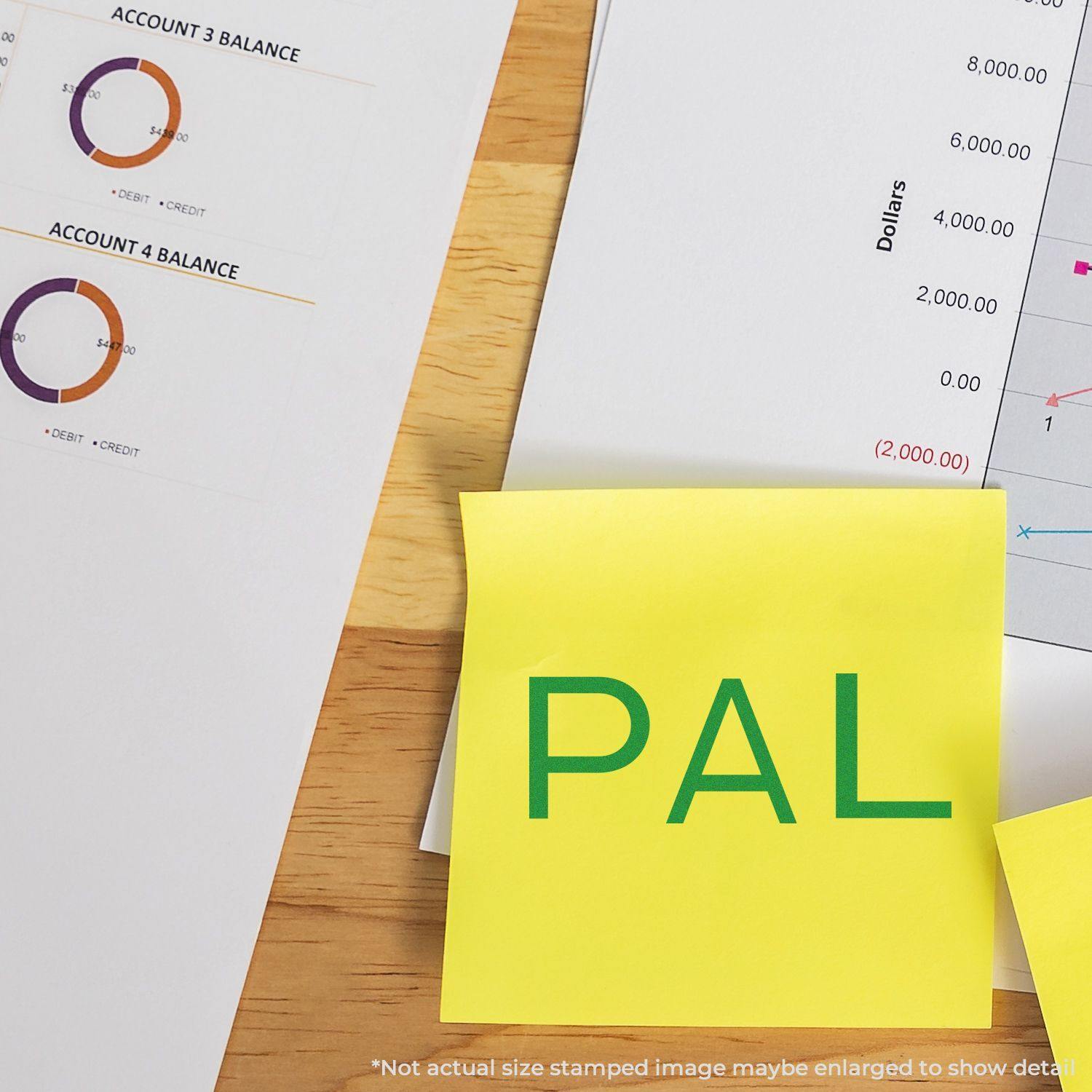 Yellow sticky note with PAL stamped in green ink using a PAL Rubber Stamp, placed on financial documents and charts.