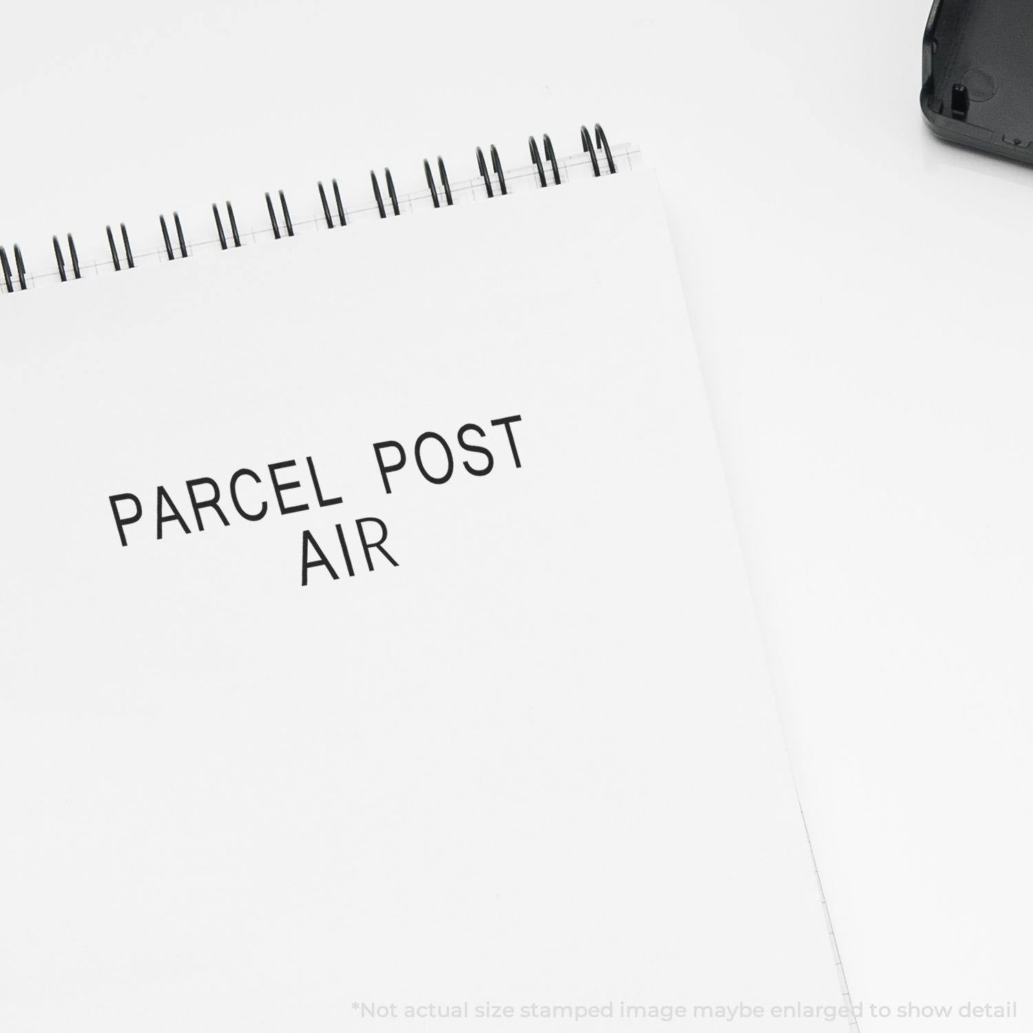 Large Pre-Inked Parcel Post Air Stamp imprint on white paper, with the stamp partially visible in the top right corner.