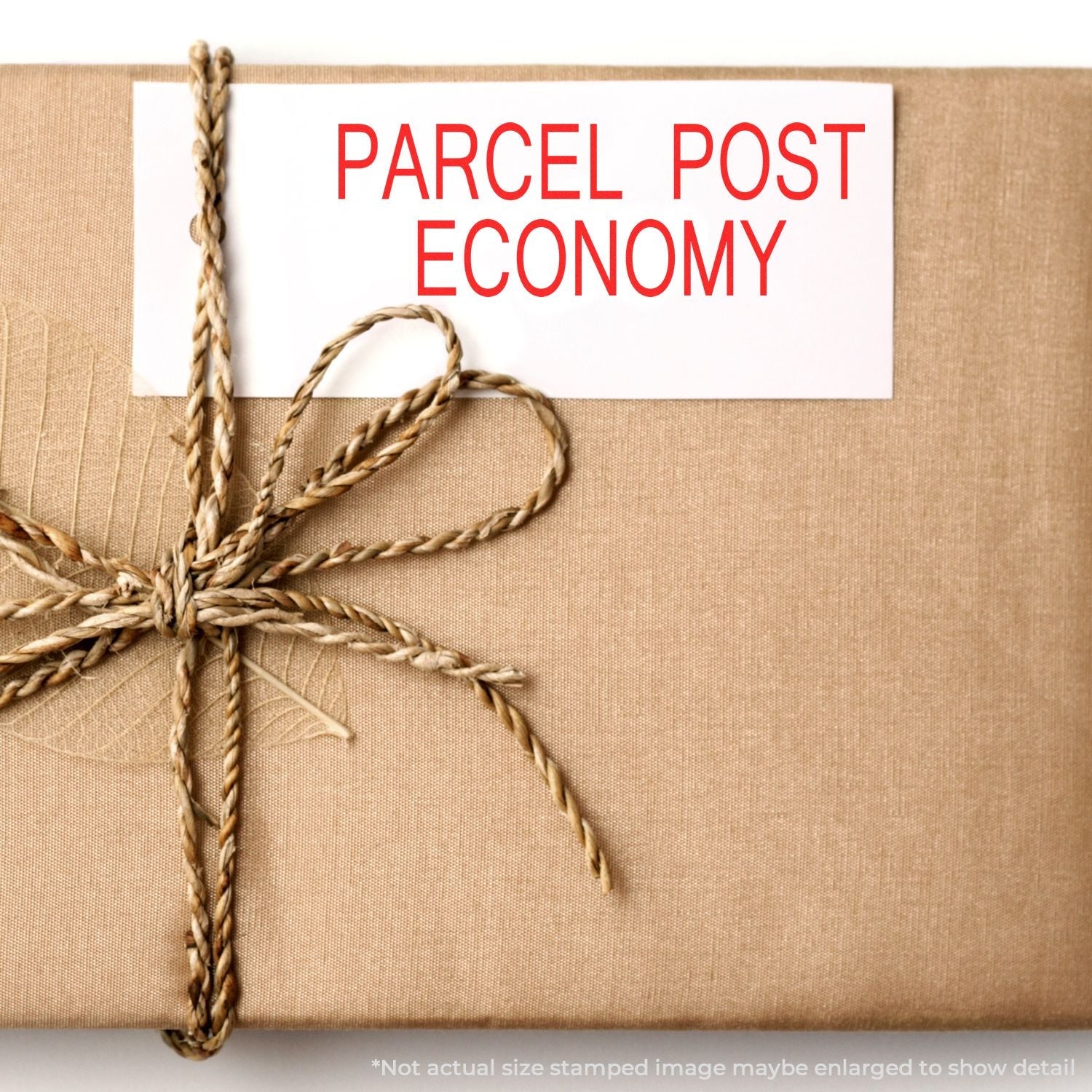 A brown parcel wrapped with twine, stamped with PARCEL POST ECONOMY using the Self Inking Parcel Post Economy Stamp.