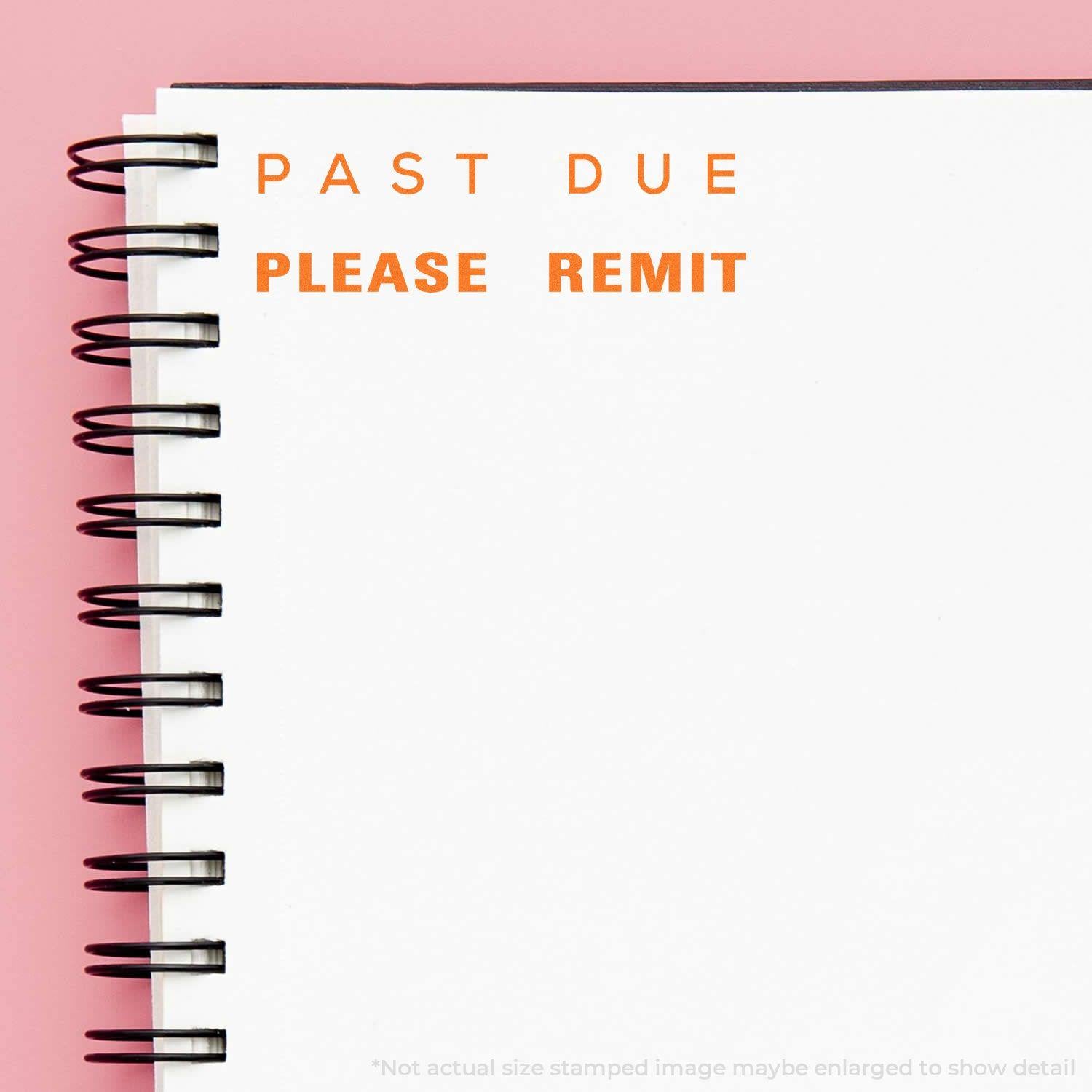 Slim Pre-Inked Past Due Please Remit Stamp used on a white spiral notebook with 'PAST DUE PLEASE REMIT' in orange ink.