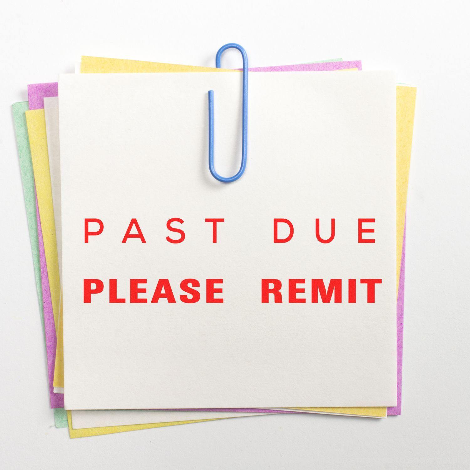 A stack of colorful papers clipped together with PAST DUE PLEASE REMIT stamped in red using the Large Past Due Please Remit Rubber Stamp.