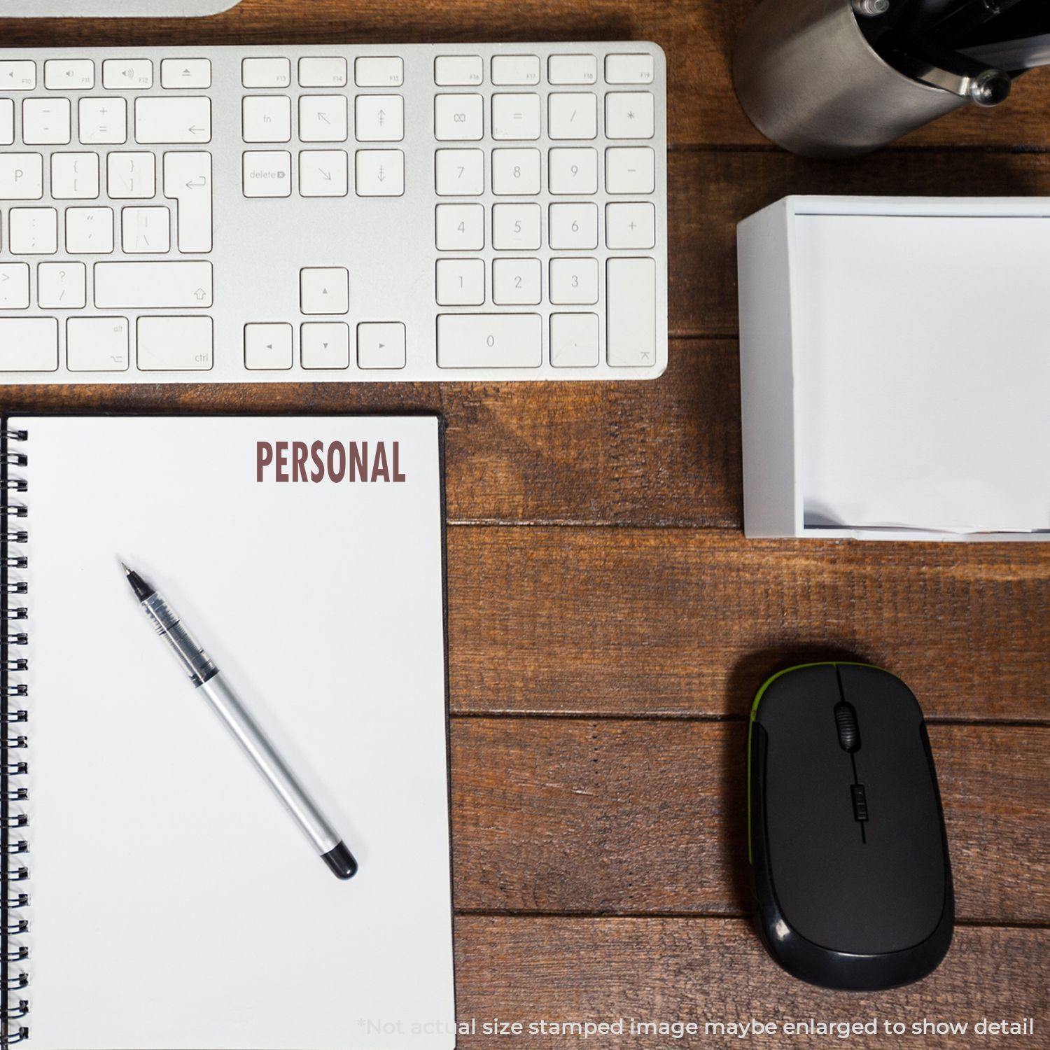 Slim Pre-Inked Personal Stamp marking PERSONAL on a notebook, placed on a wooden desk with a keyboard, mouse, pen, and box.