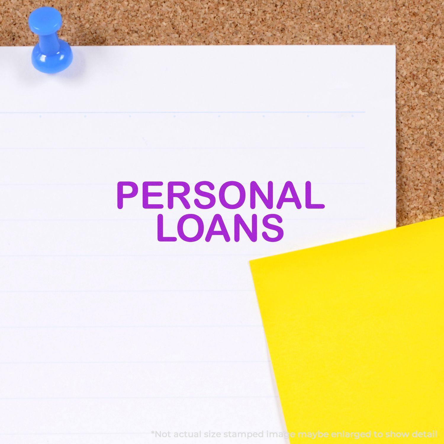 Slim Pre-Inked Personal Loans Stamp in purple ink on white paper pinned to a corkboard with a blue pushpin and yellow note.