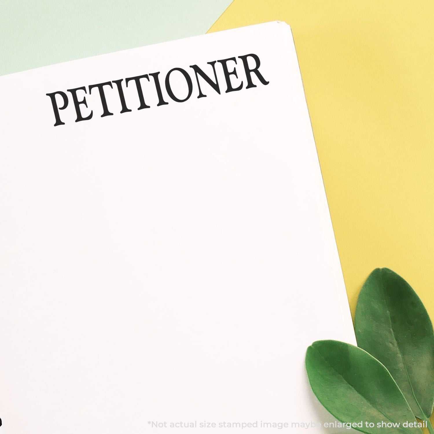 Self Inking Petitioner Stamp used on white paper, with green leaves on a yellow and green background.