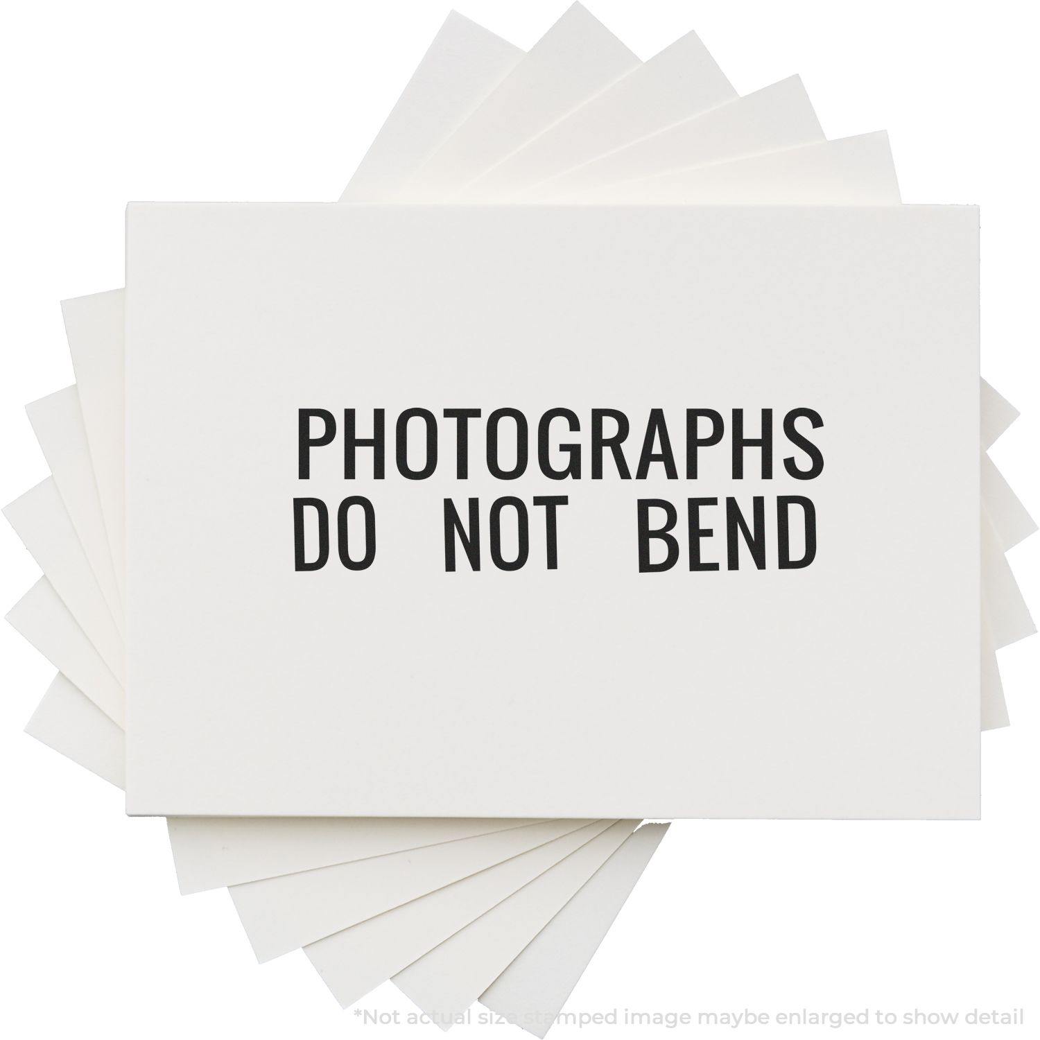 Large Photographs Do Not Bend Rubber Stamp used on a stack of white envelopes, ensuring photographs remain flat and undamaged.