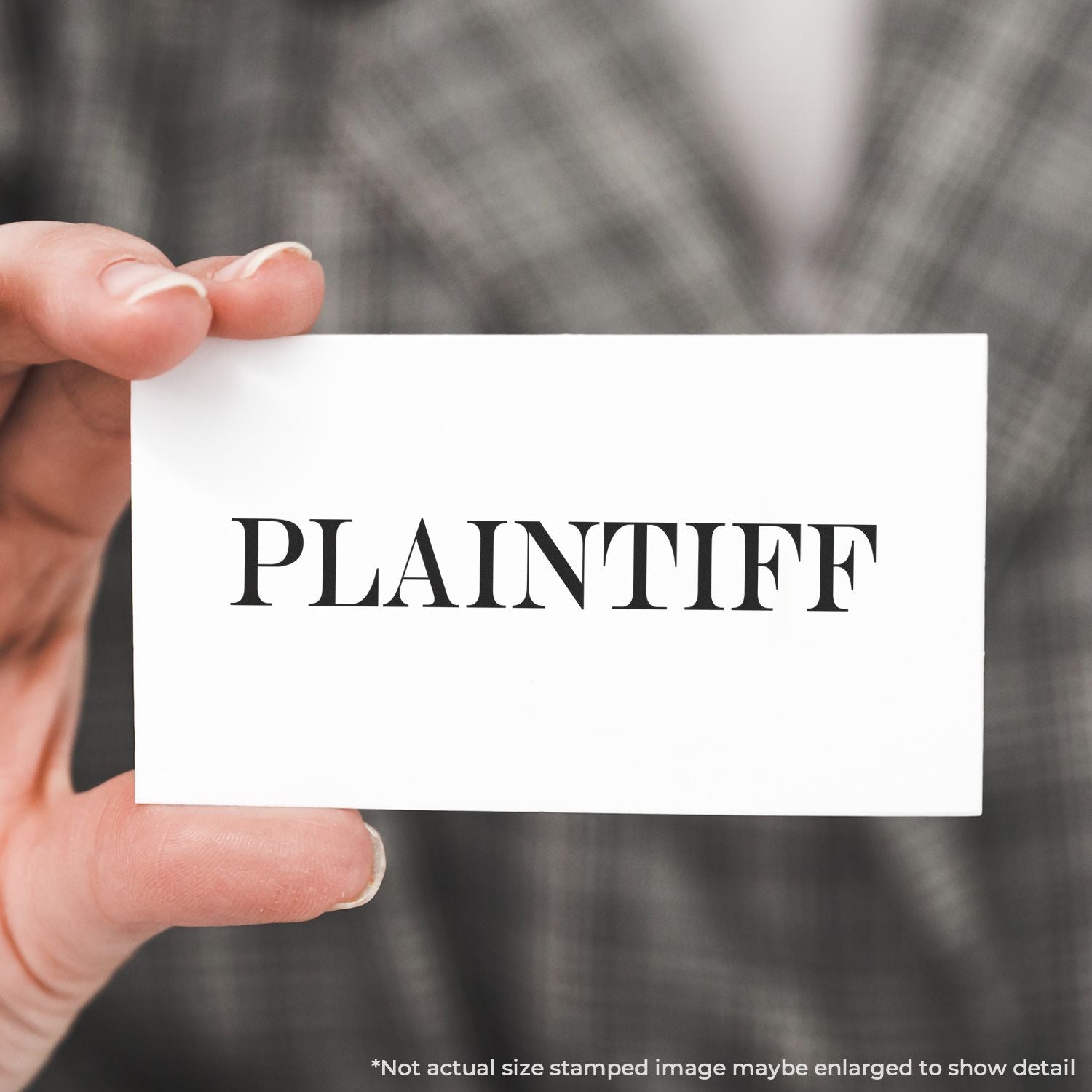 Person holding a white card stamped with PLAINTIFF using a Self Inking Plaintiff Stamp, with a blurred background.