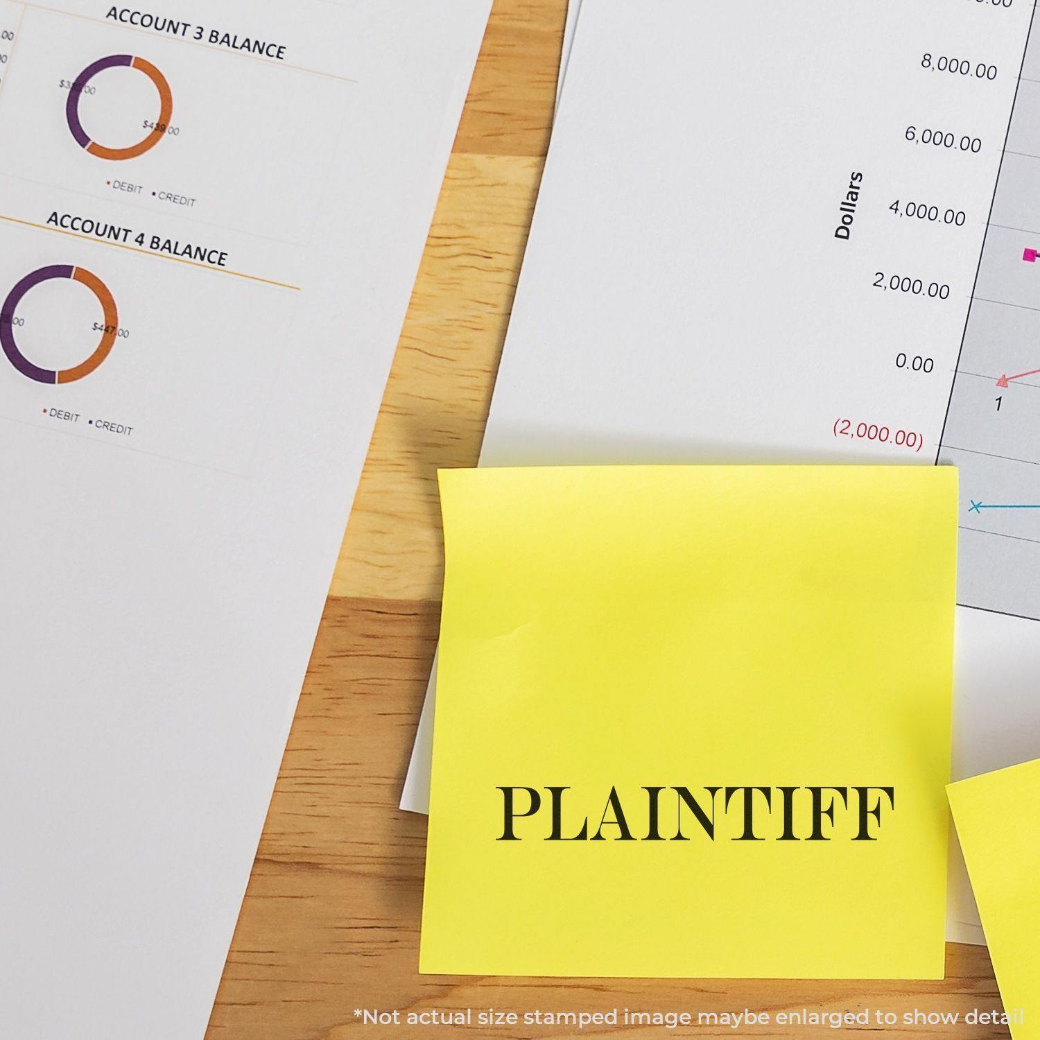 Large Pre-Inked Plaintiff Stamp used on a yellow sticky note, placed on a desk with financial documents and charts in the background.