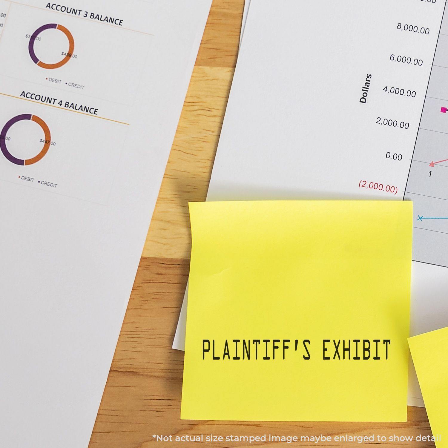 Large Plaintiffs Exhibit Rubber Stamp used on a yellow sticky note, placed on financial documents with charts and graphs on a wooden desk.