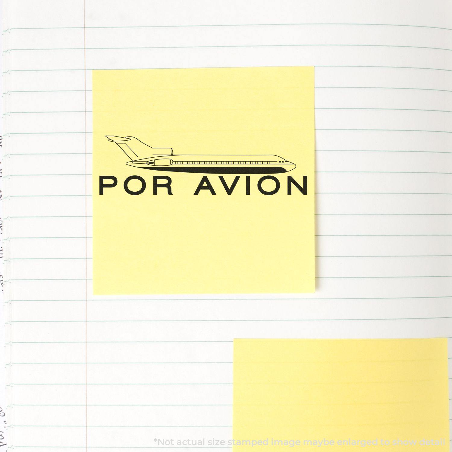 Large Por Avion Rubber Stamp used on a yellow sticky note, depicting an airplane and the text POR AVION on a lined notebook page.