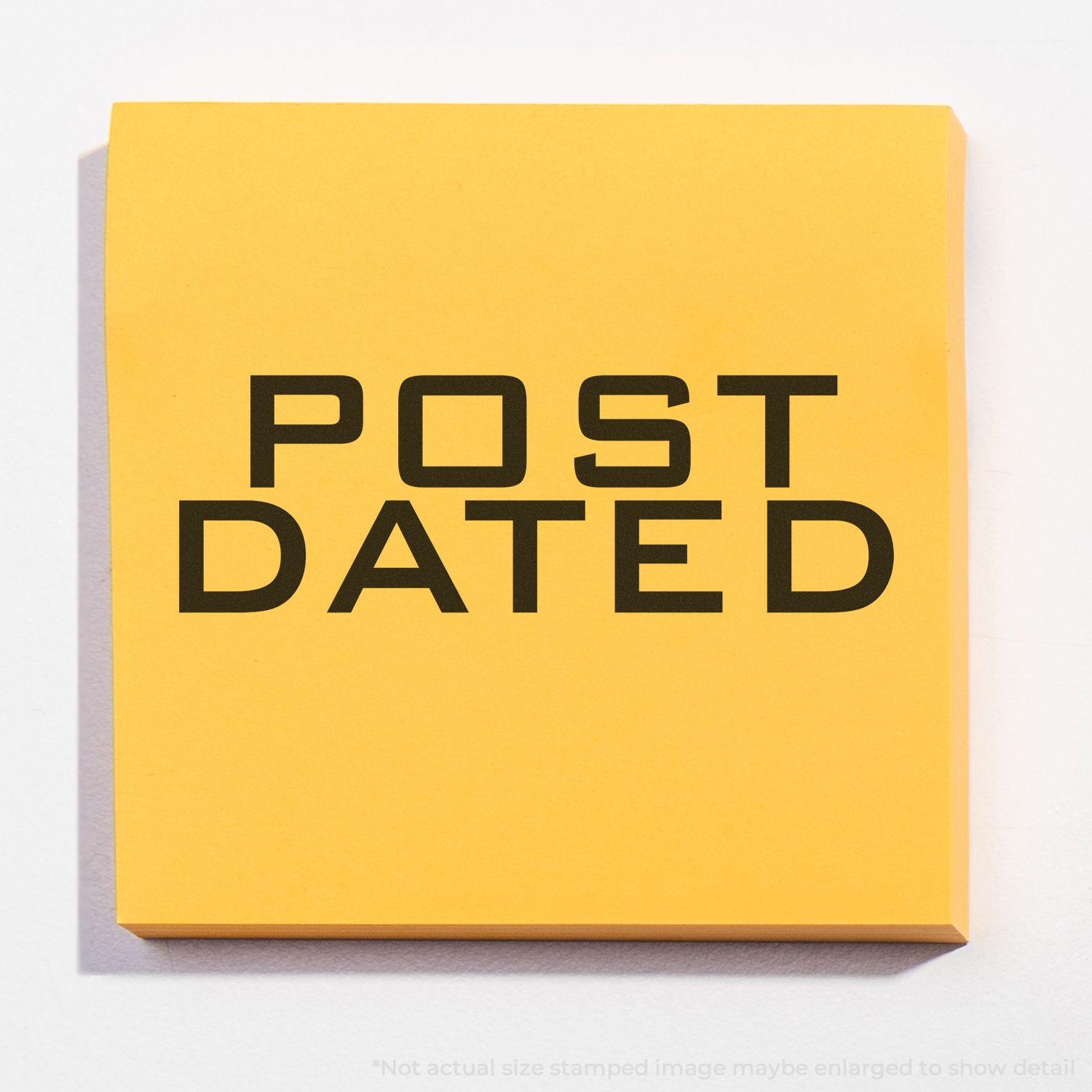 Self Inking Post Dated Stamp on a yellow sticky note with the words POST DATED stamped in bold black letters.