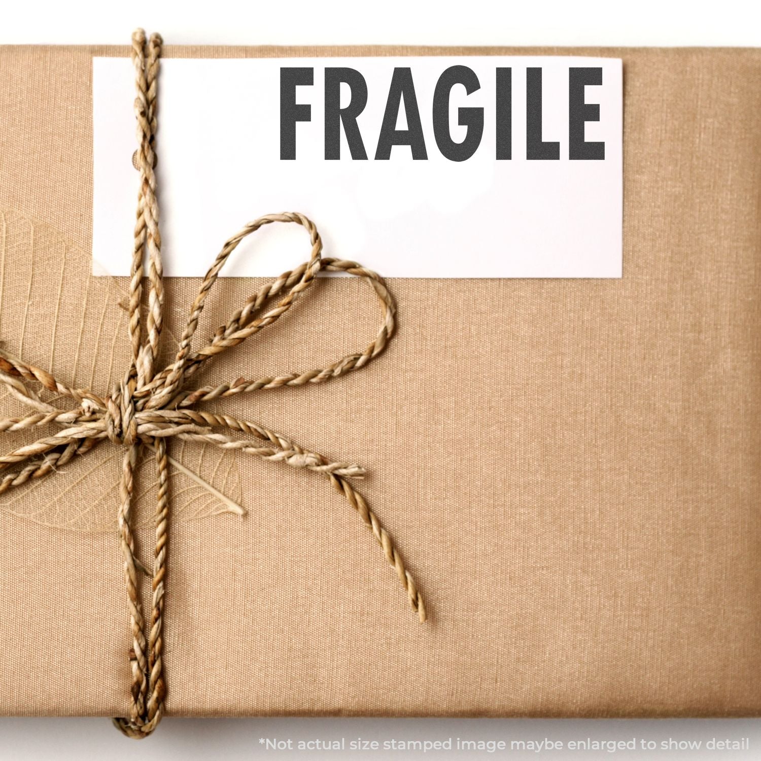 A brown package tied with twine, stamped with FRAGILE using a Self Inking Fragile Stamp.