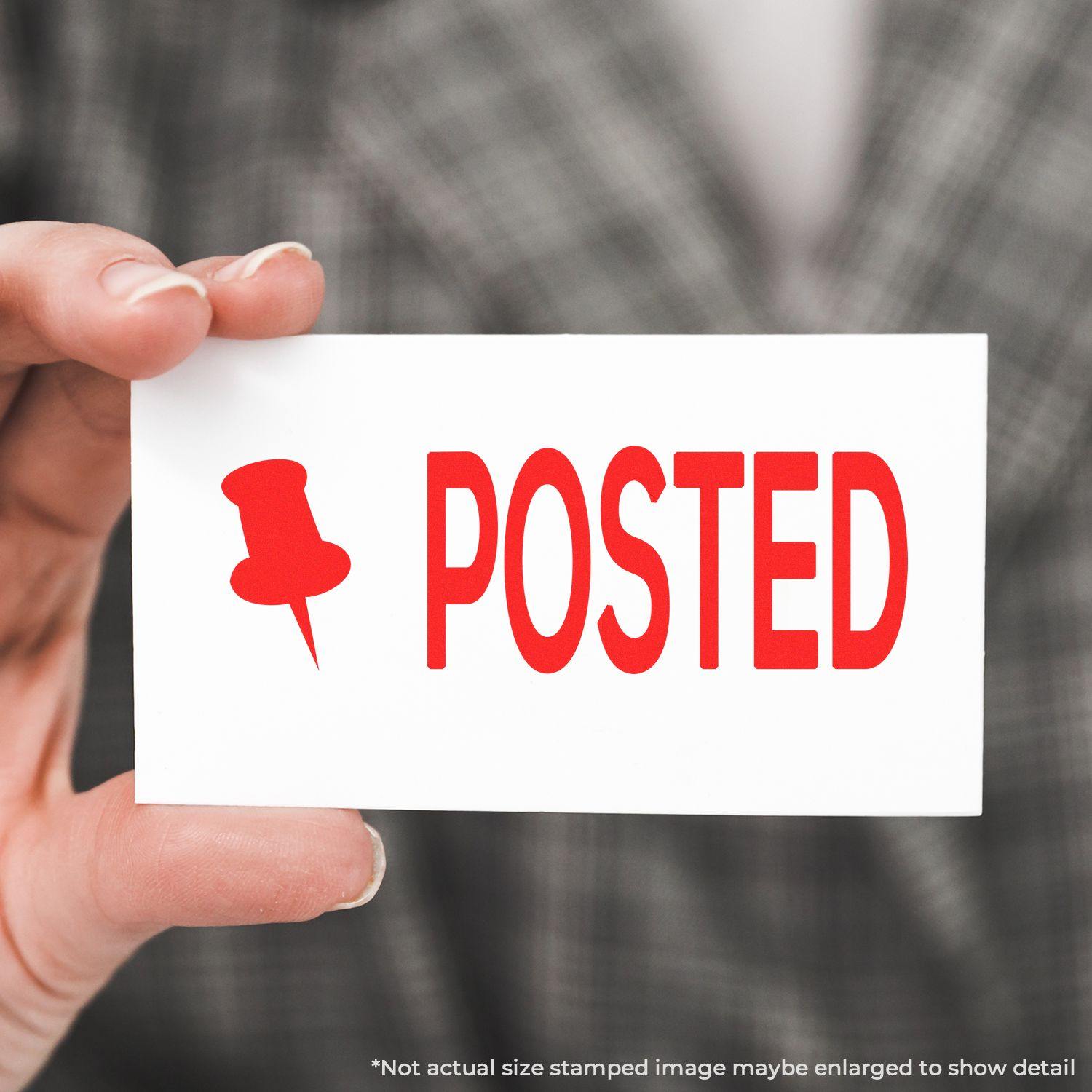 Hand holding a white card with Posted with Thumbtack Rubber Stamp in red text and a red thumbtack icon on it.