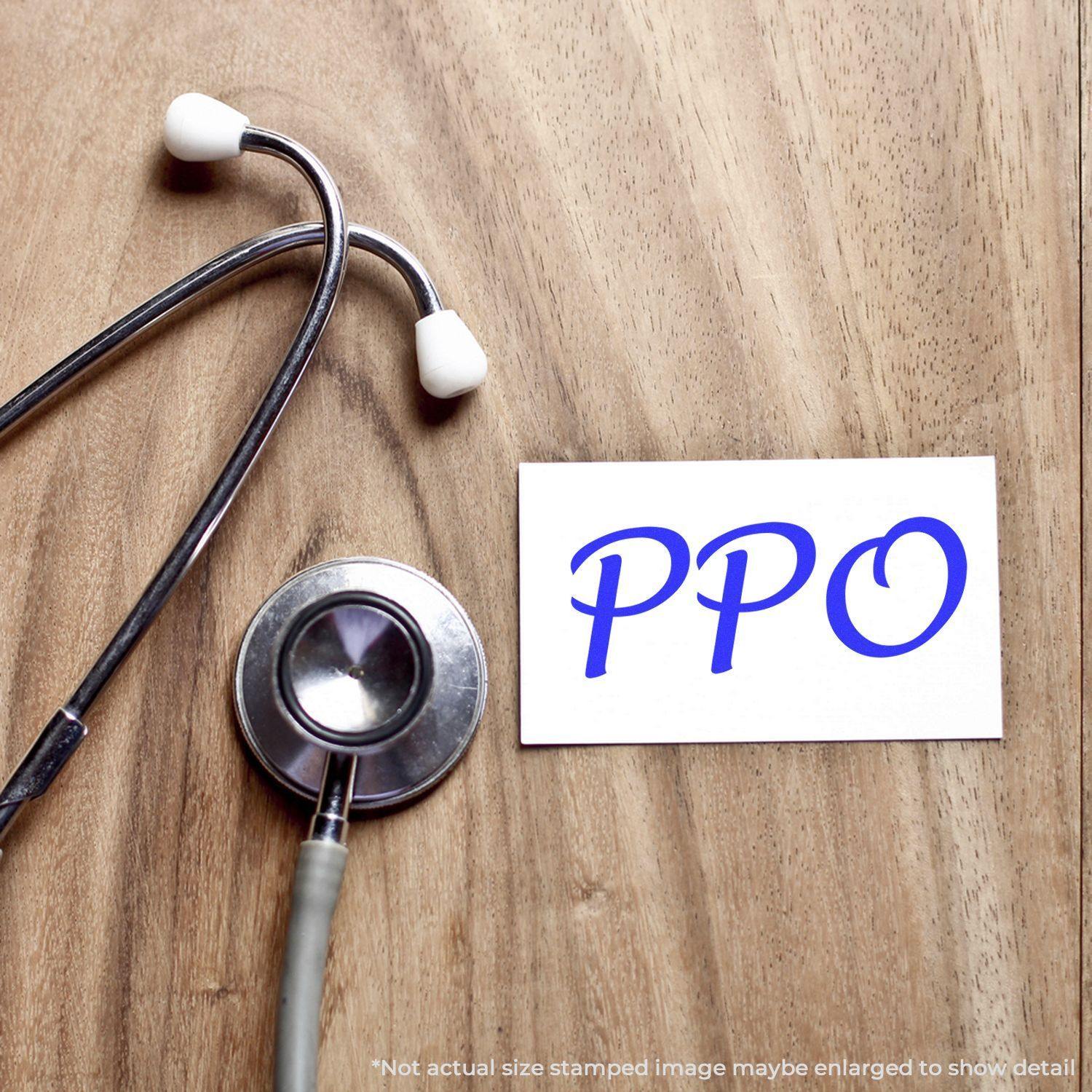 Large Self Inking PPO Stamp on a wooden surface next to a stethoscope, showing the stamped text PPO in blue on a white card.