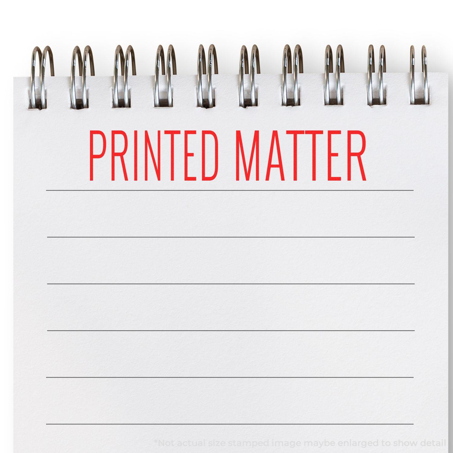 Large Self Inking Printed Matter Stamp used on a lined notepad, showing the text PRINTED MATTER in red ink.