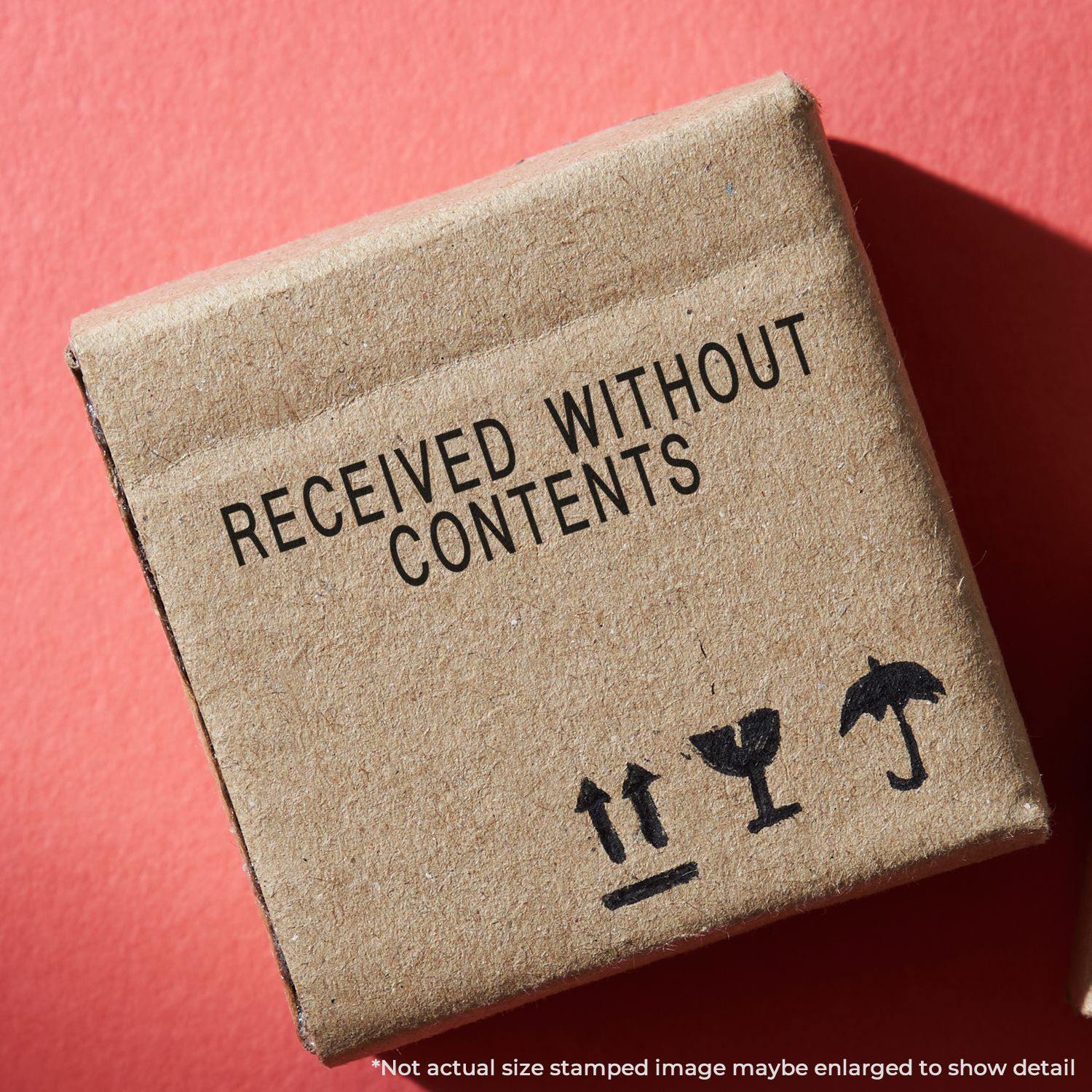 A cardboard box stamped with RECEIVED WITHOUT CONTENTS using the Large Received Without Contents Rubber Stamp on a red background.