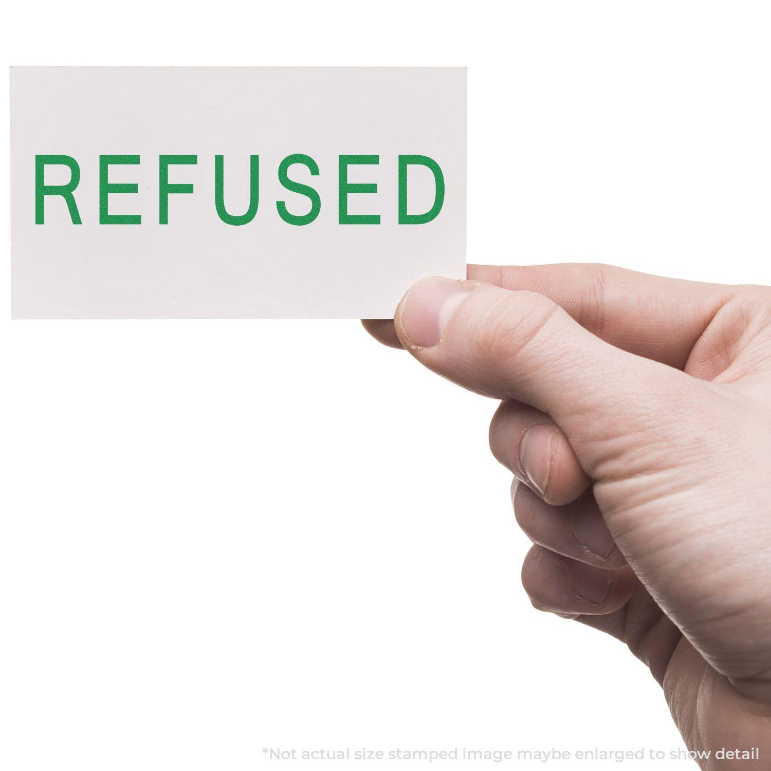 A hand holding a white card stamped with REFUSED in green using the Large Self Inking Refused Stamp.