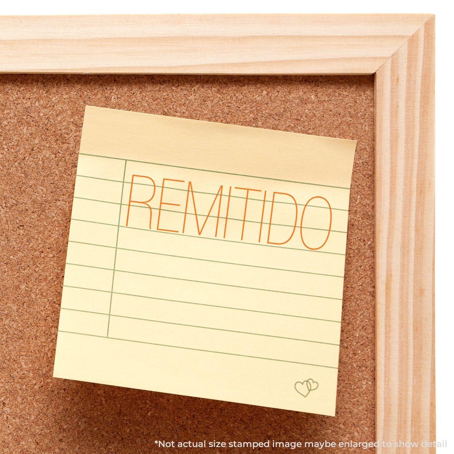 Yellow sticky note on corkboard stamped with REMITIDO using a Slim Pre-Inked Remitido Stamp, showing clear and precise text.