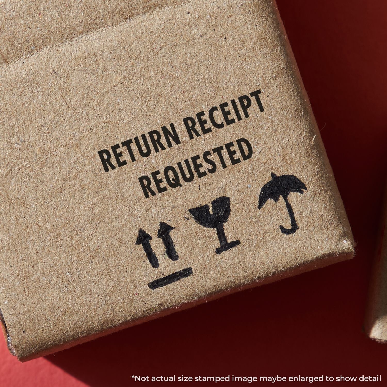 Close-up of a cardboard box stamped with Return Receipt Requested using the Self Inking Return Receipt Requested Stamp.