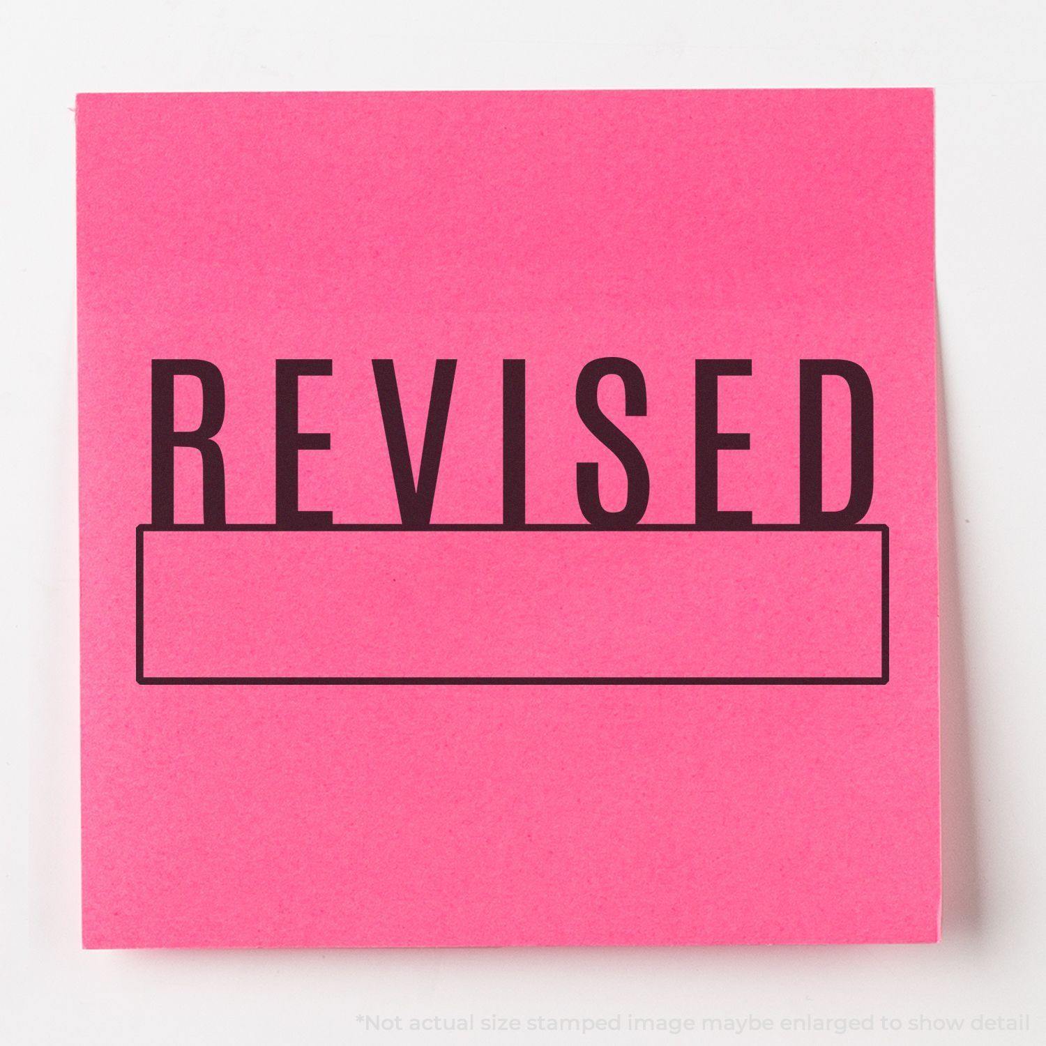 Large Pre-Inked Revised with Box Stamp on a pink paper, showing the word REVISED in bold black letters with an empty box below it.