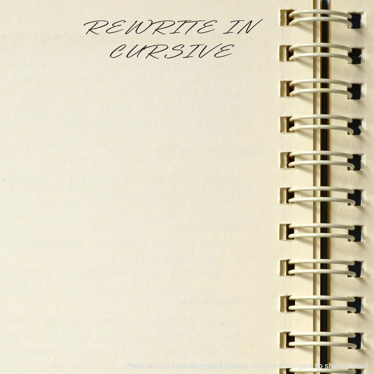 Slim Pre-Inked Rewrite In Cursive Stamp used on a spiral-bound notebook, displaying 'REWRITE IN CURSIVE' text.