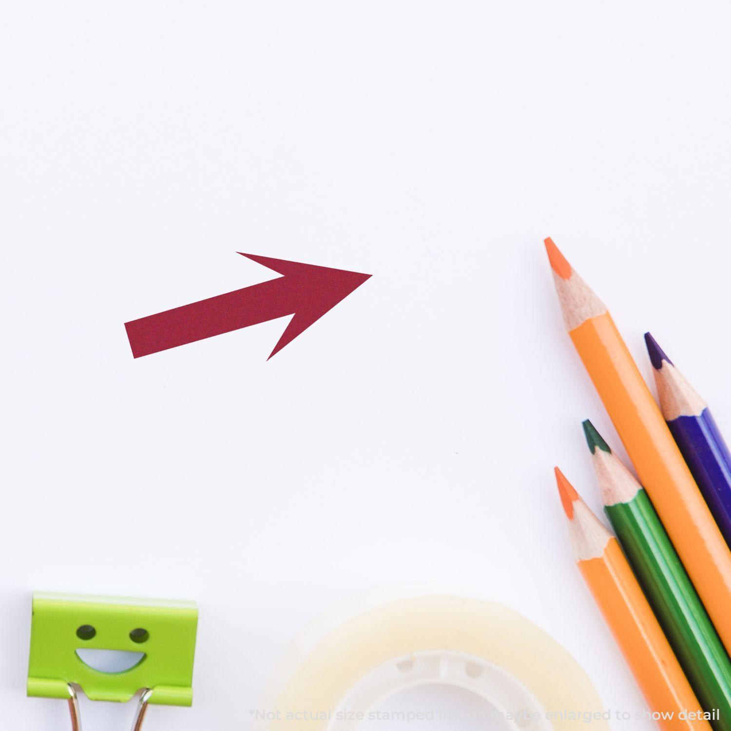 Round Arrow Rubber Stamp in red ink on white paper, surrounded by colorful pencils, a smiling binder clip, and tape.